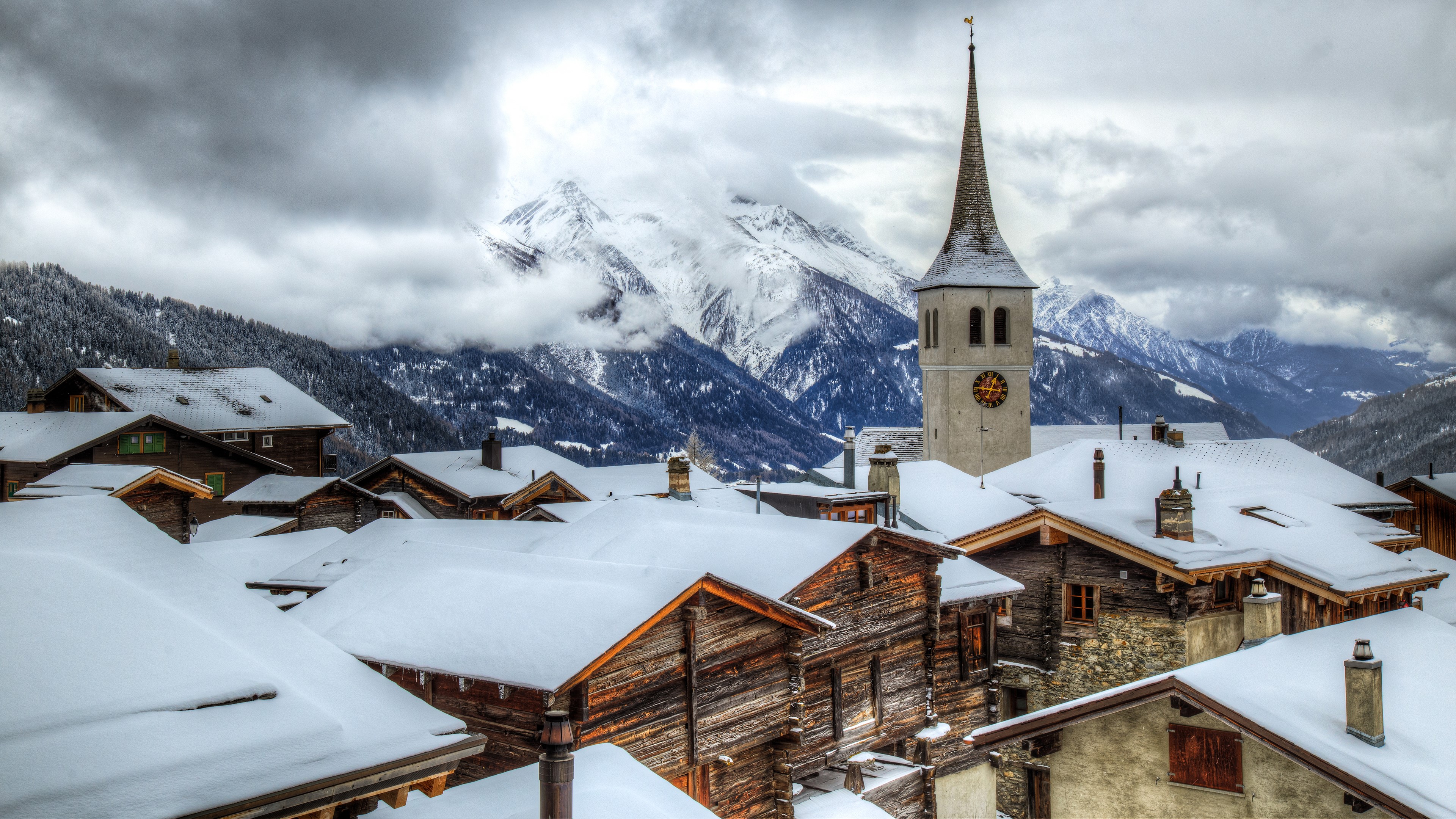Snowy village with church and mountains HD Wallpaper