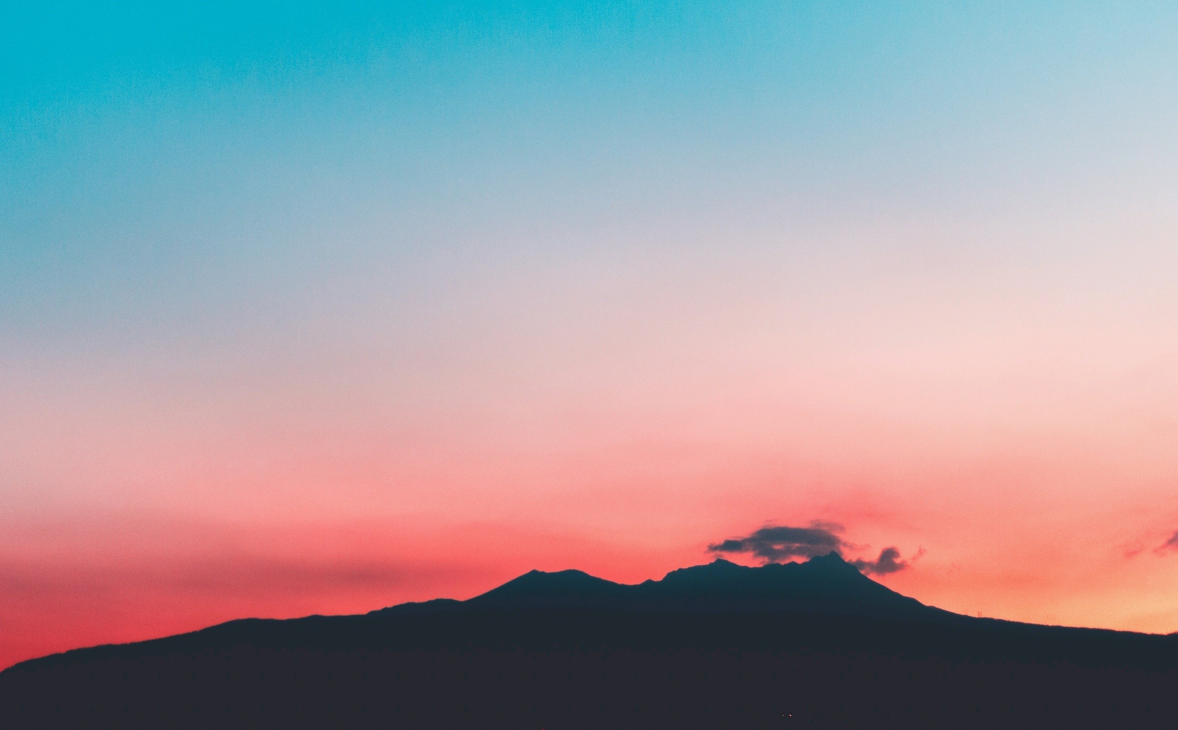 Silhouette of mountains against a colorful sunset sky HD Wallpaper