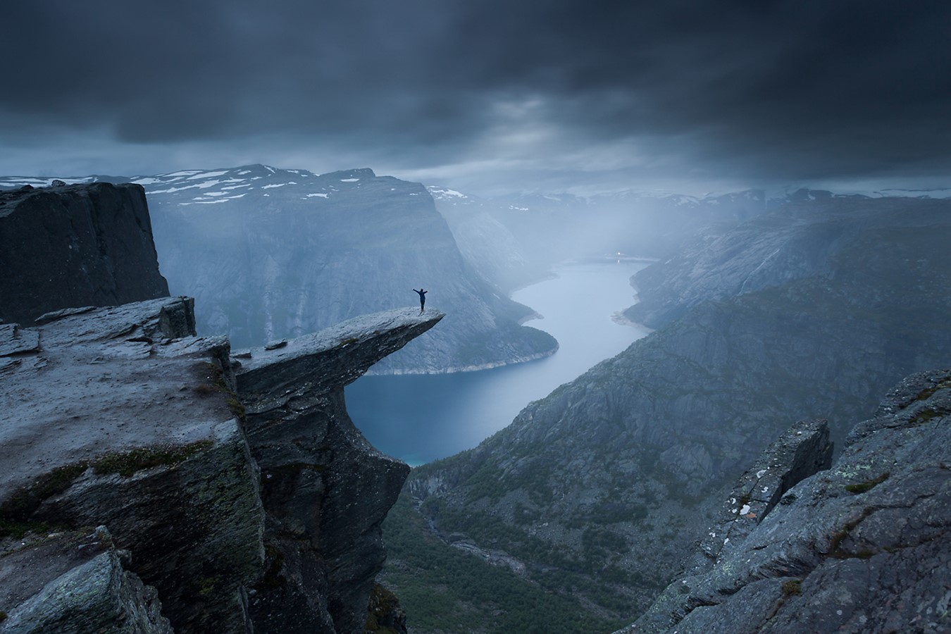 Person standing on Trolltunga rock in Norway HD Wallpaper