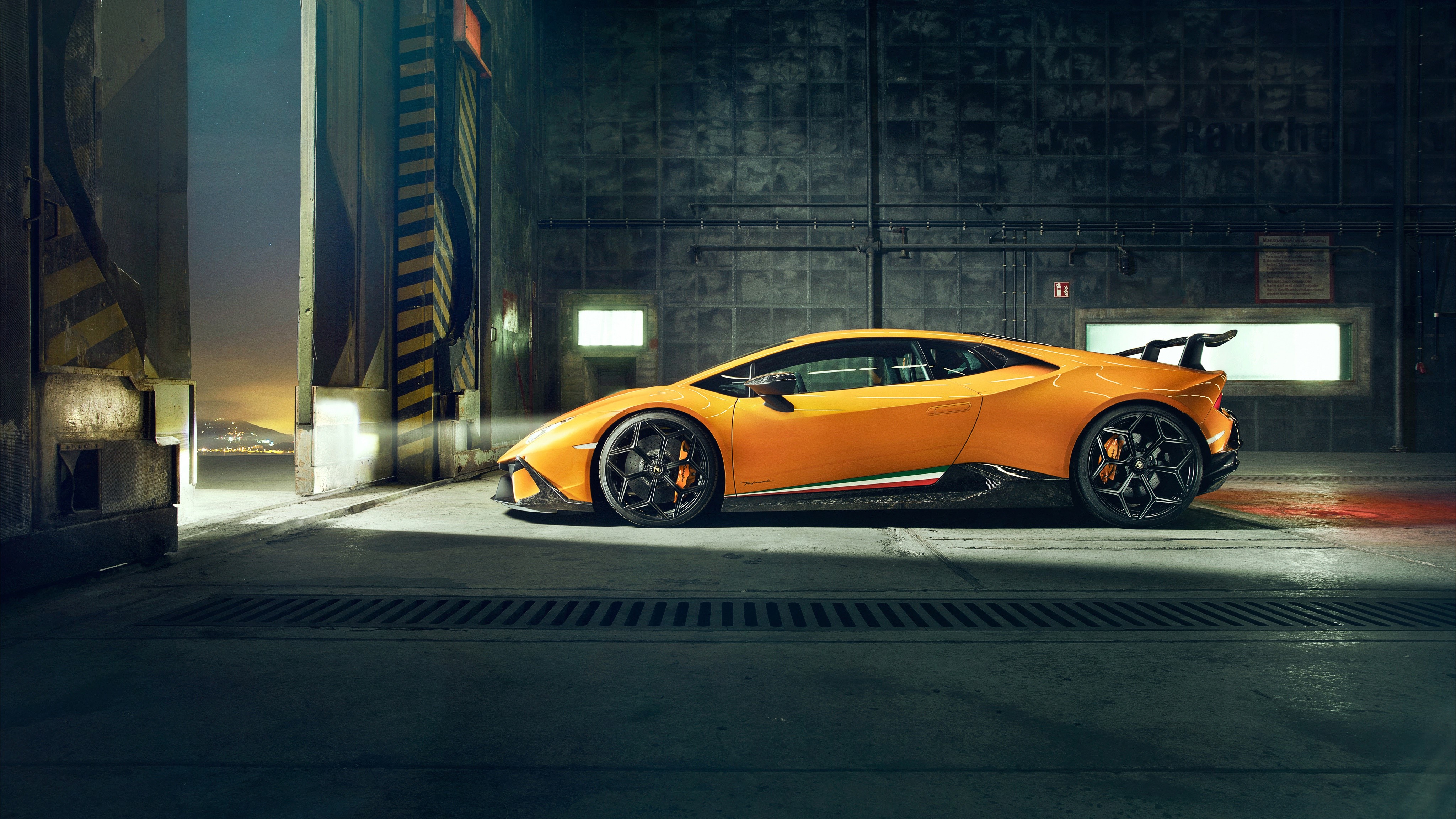 Orange Lamborghini Huracan in a Hangar HD Wallpaper