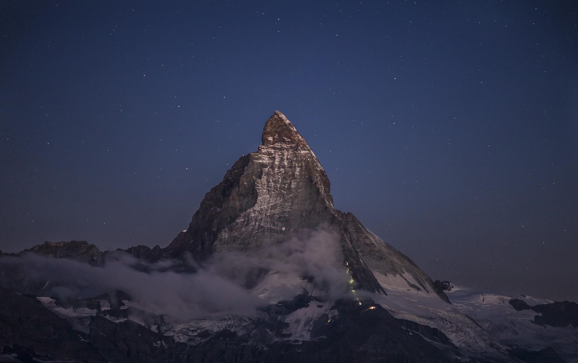 Matterhorn mountain peak at night with stars HD Wallpaper