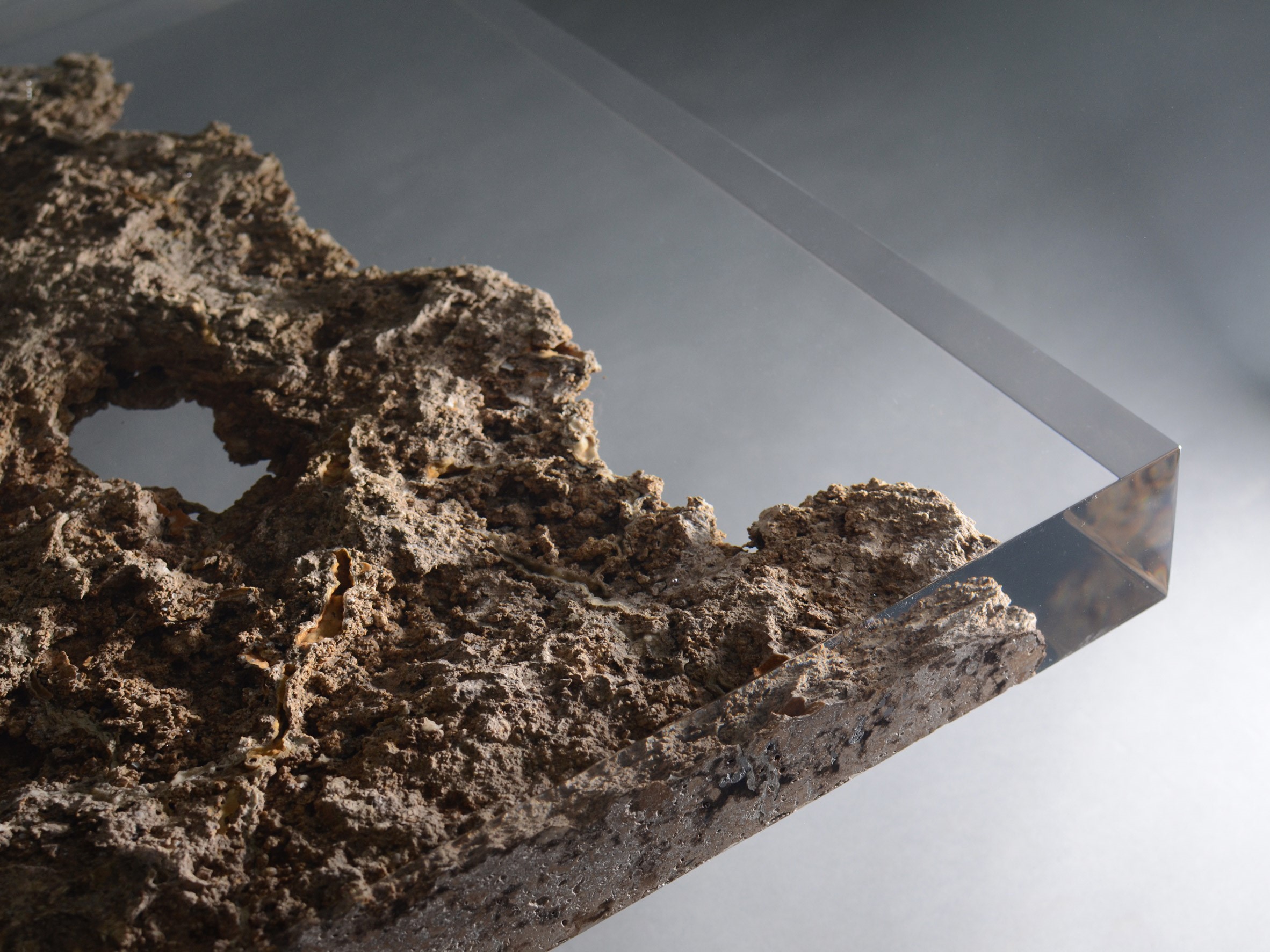 Rock formation encased in clear resin on a table HD Wallpaper
