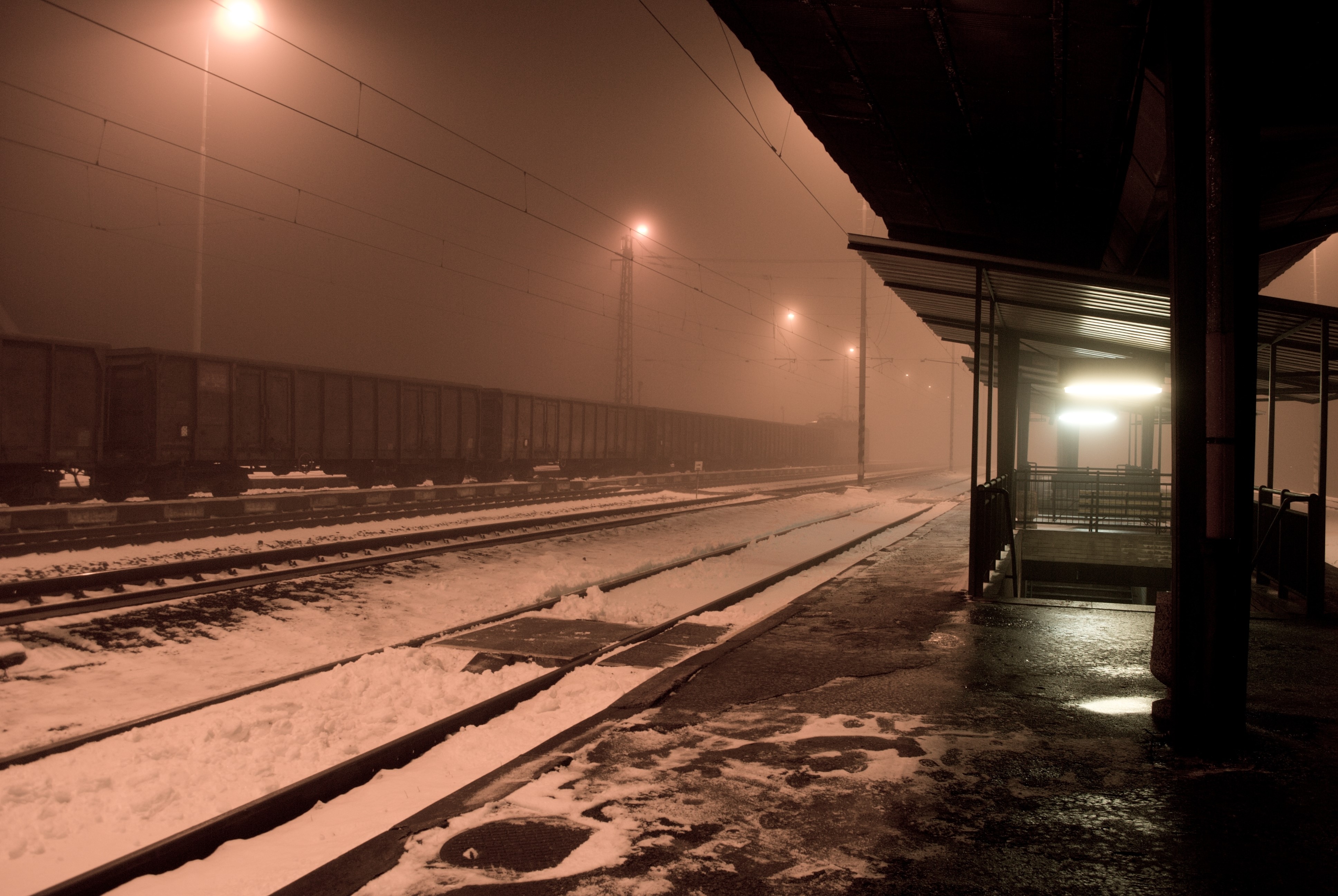 Train station at night in winter with snow and mist HD Wallpaper