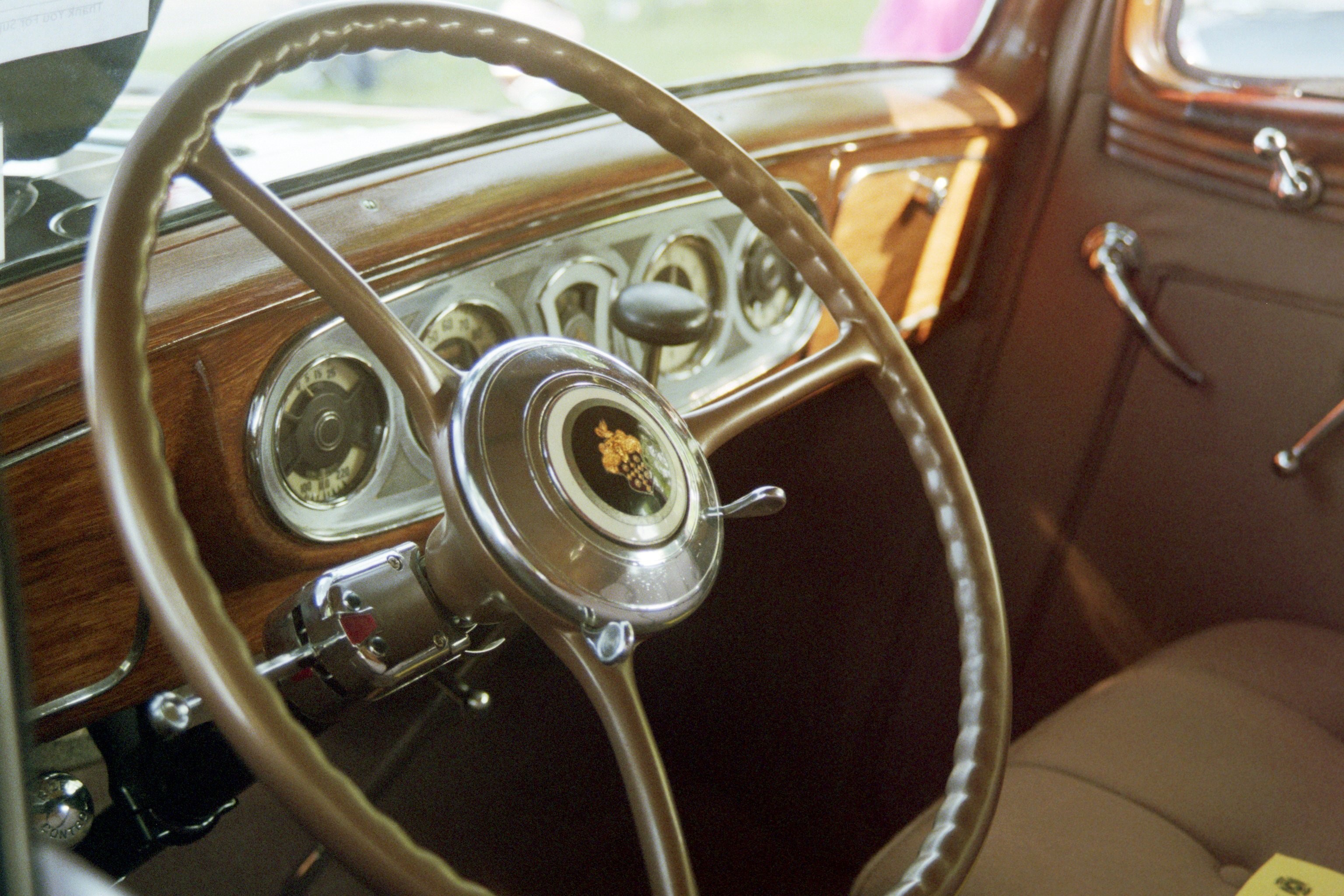 Vintage car interior with wood dashboard and steering wheel HD Wallpaper