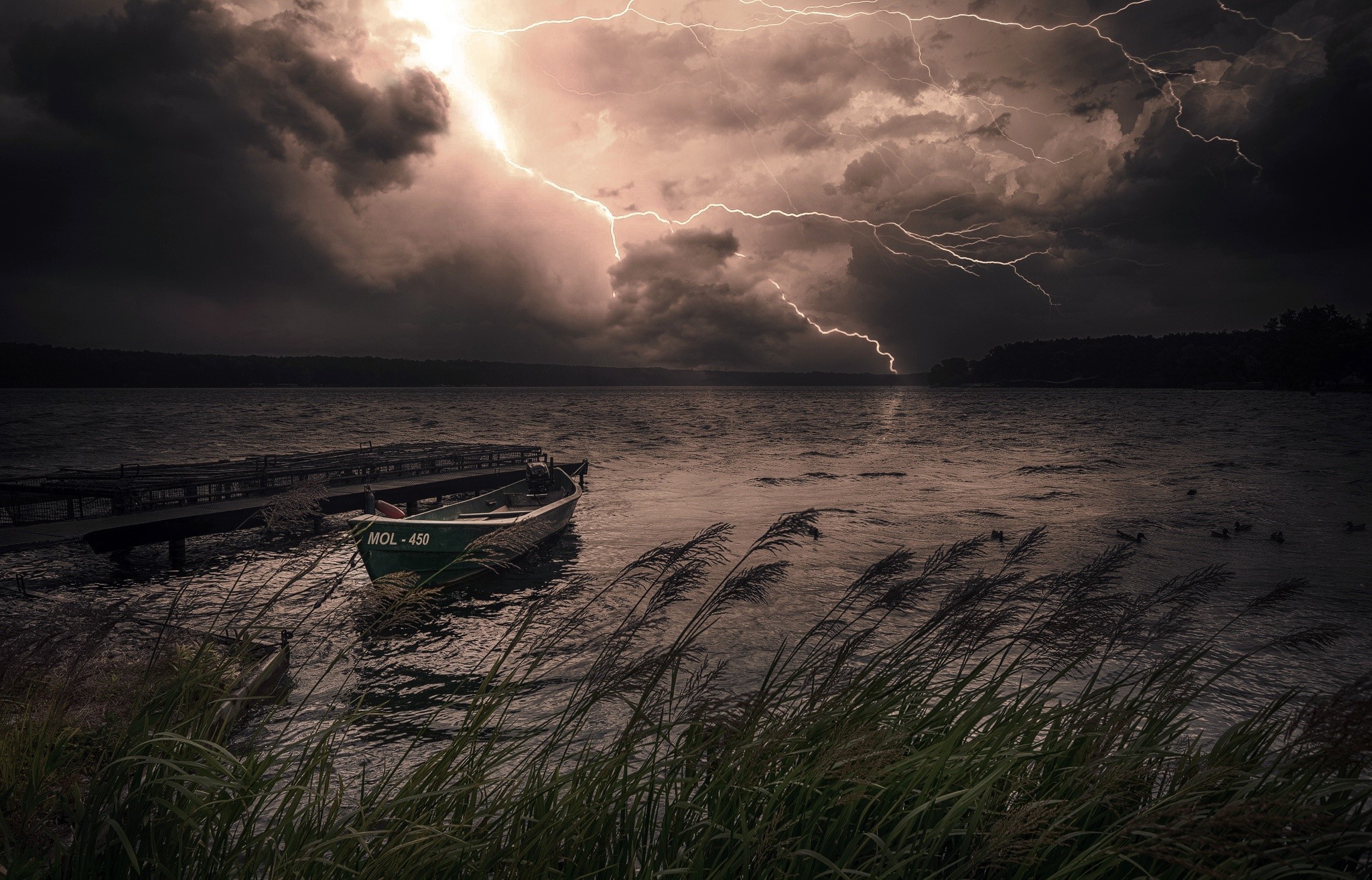 Lightning strikes over a lake with a boat and pier HD Wallpaper