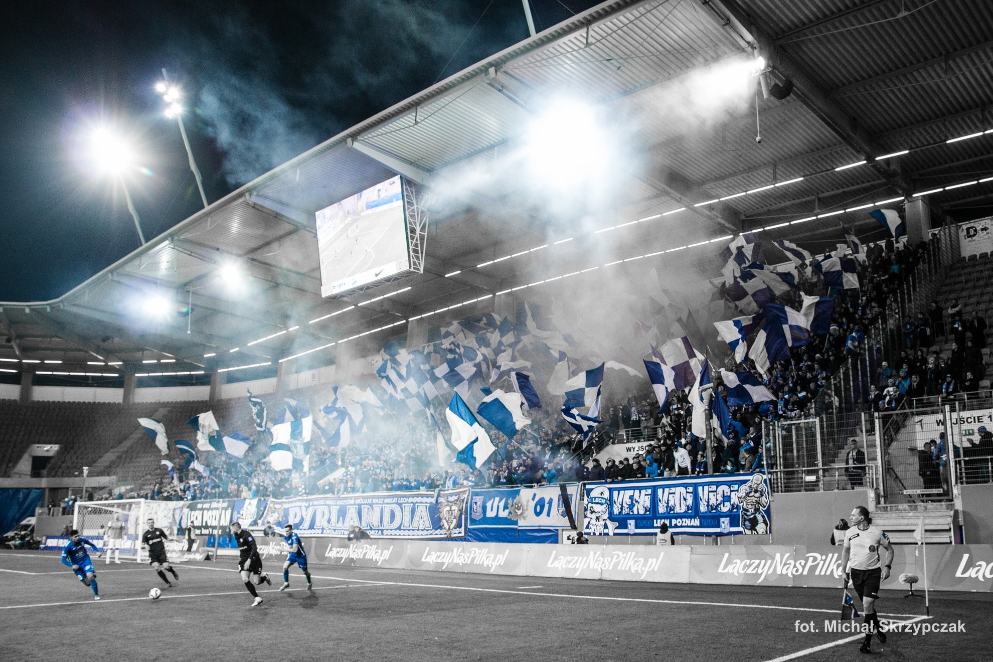 Football match with fans waving flags in stadium HD Wallpaper