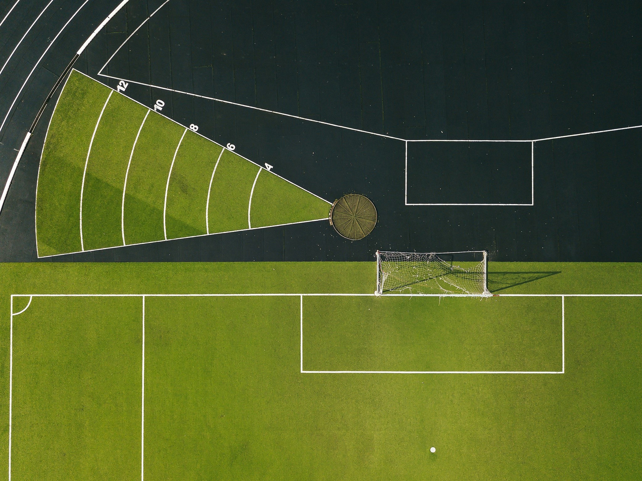 Aerial view of a sports field with running track HD Wallpaper