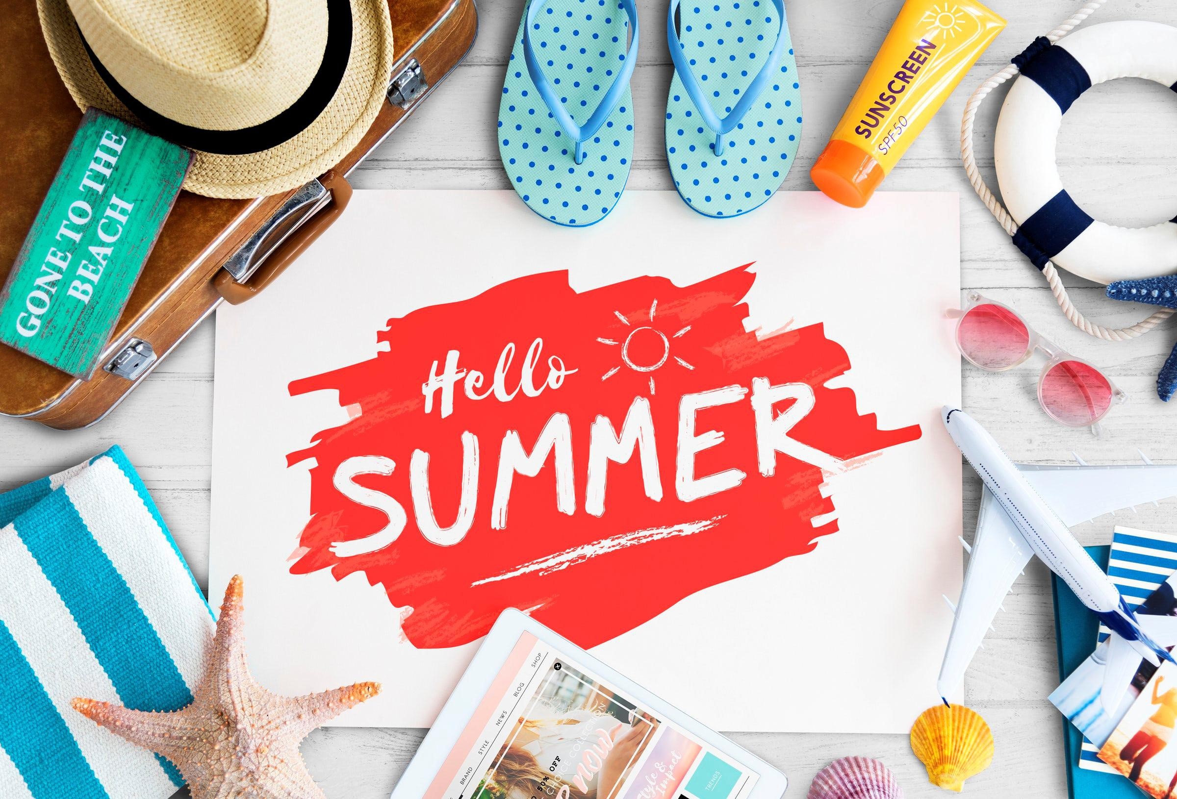 Summer vacation items laid out on a wooden surface HD Wallpaper