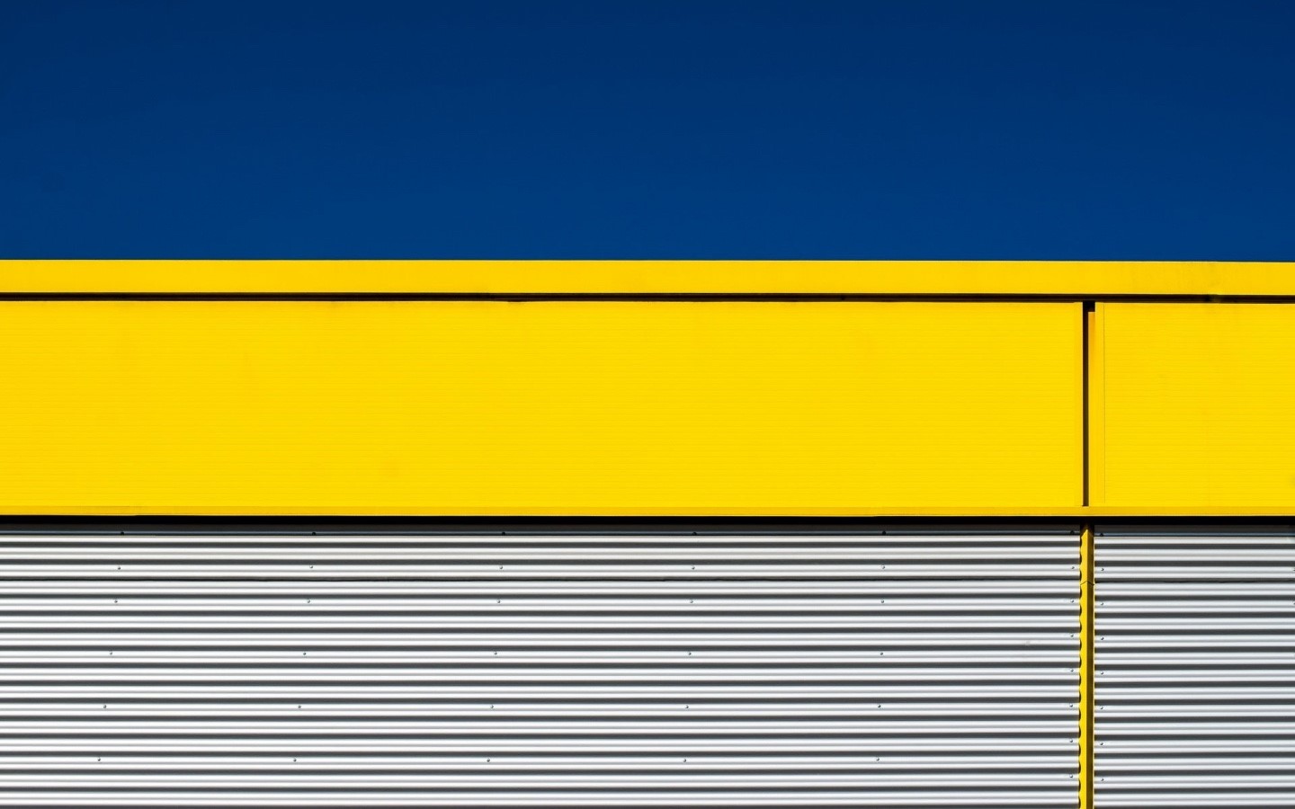 Abstract Yellow and Blue Building Facade with Corrugated Metal HD Wallpaper