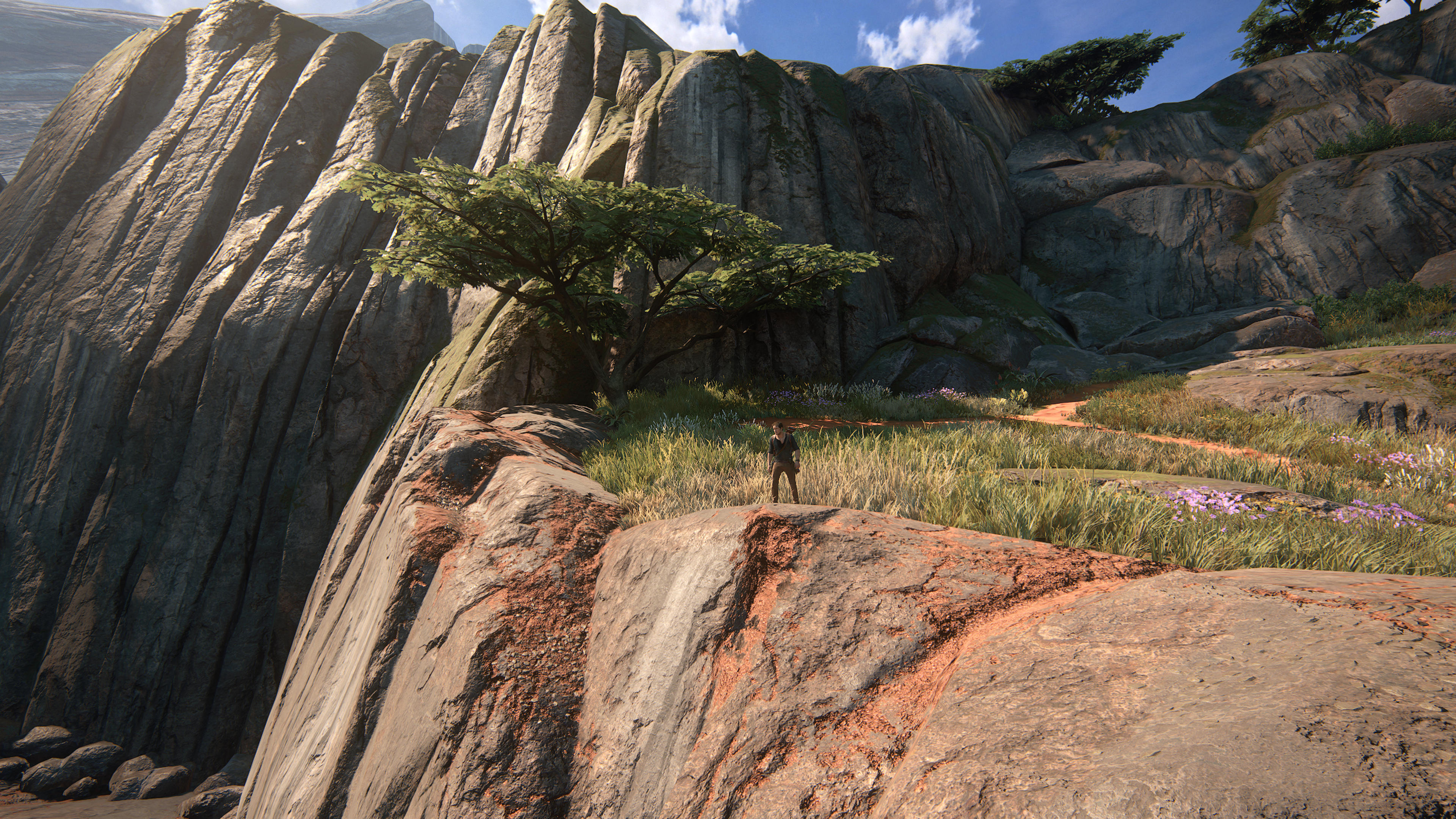 Nathan Drake from Uncharted 4: A Thief's End on a rocky cliff HD Wallpaper