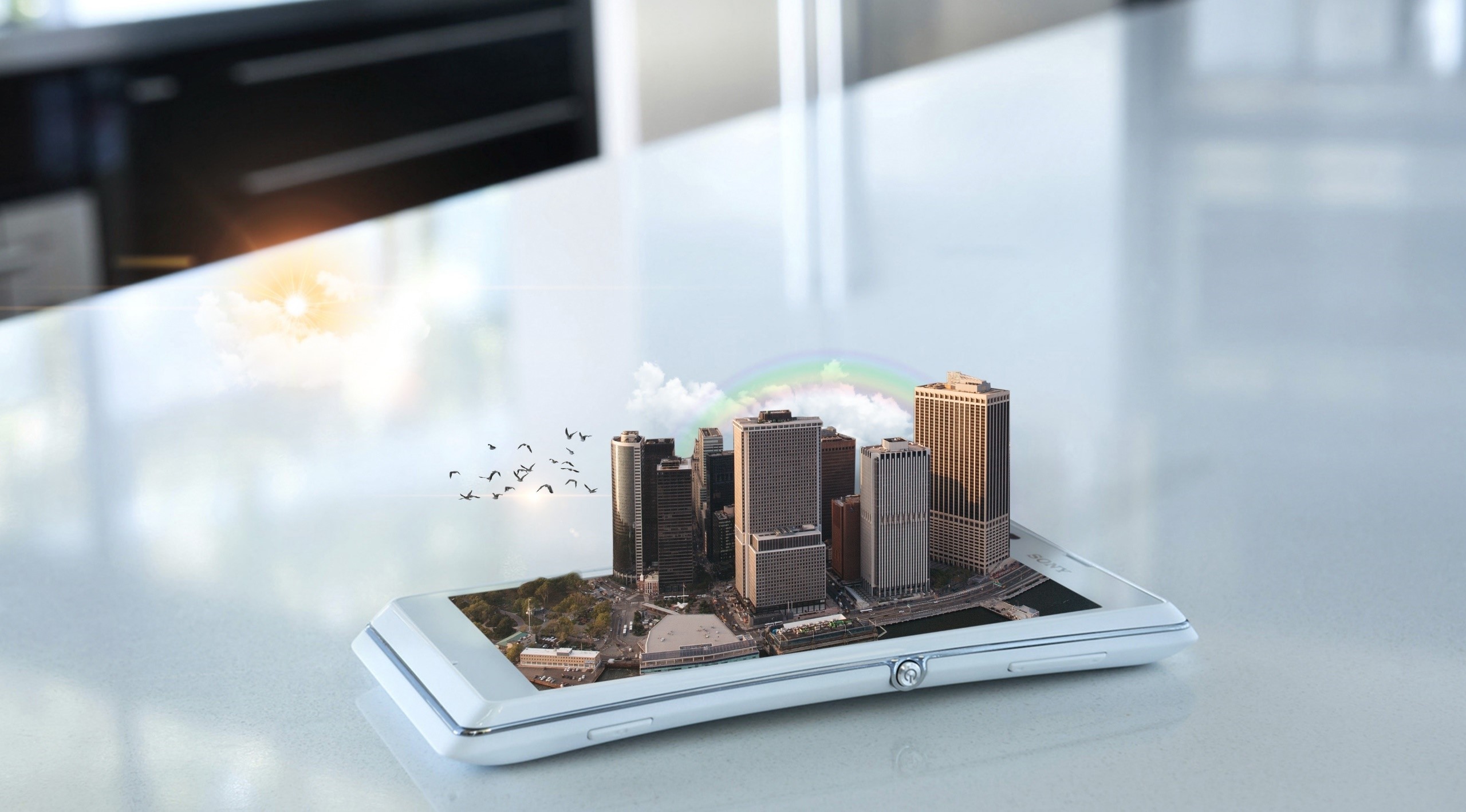 Smartphone displaying a 3D city model with birds and a rainbow HD Wallpaper