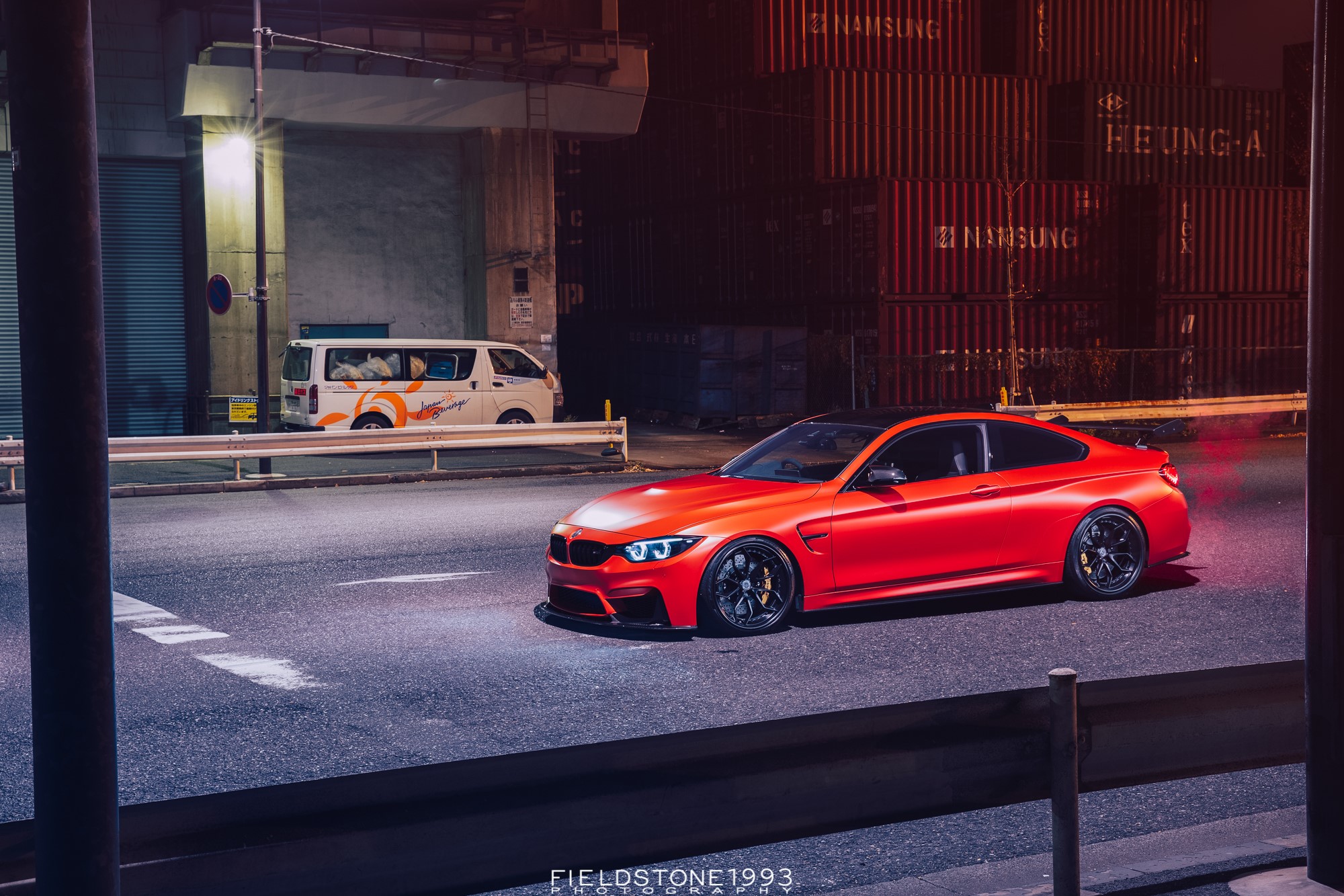 Red BMW M4 parked on a street at night HD Wallpaper