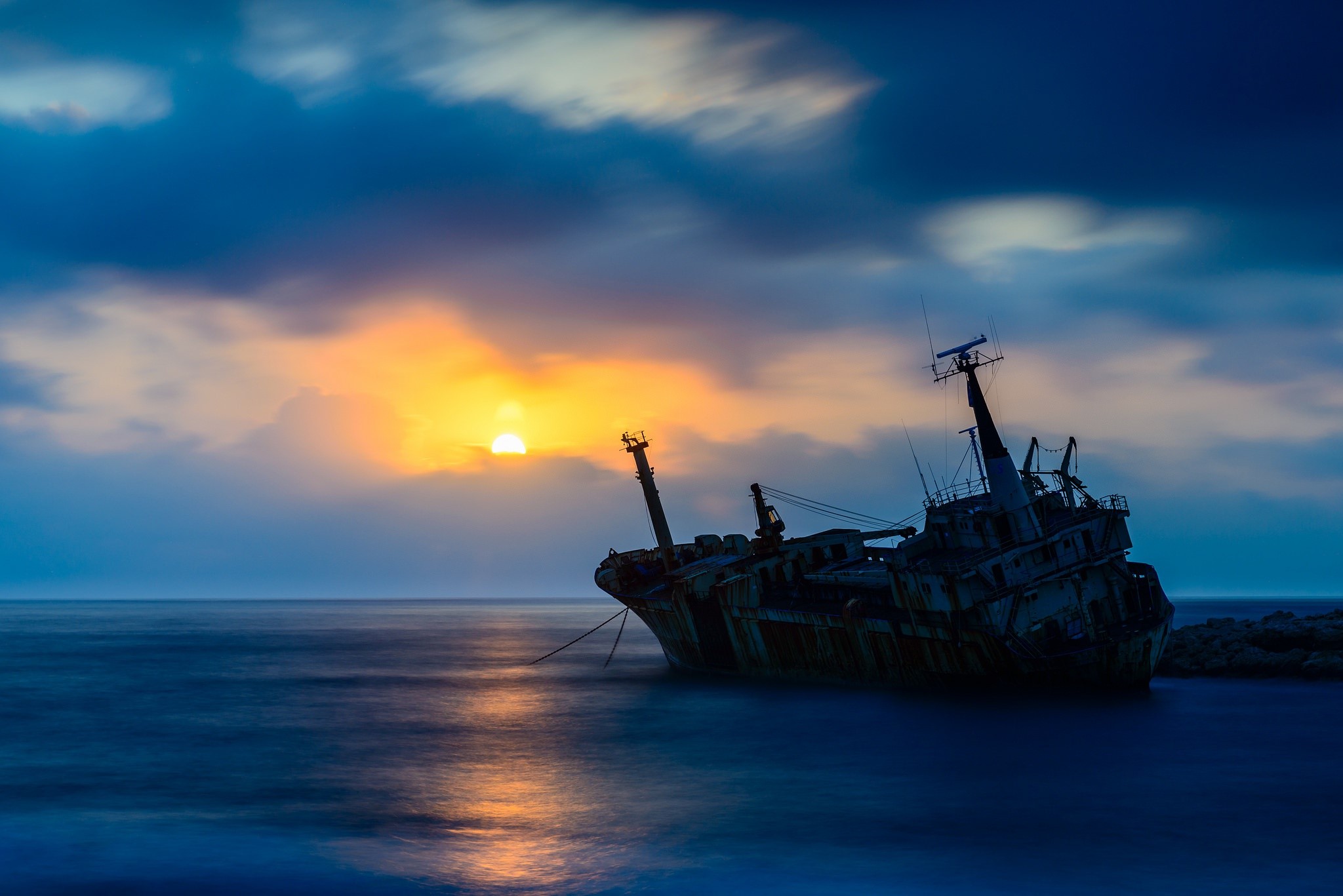 Shipwreck at sunset over the sea HD Wallpaper