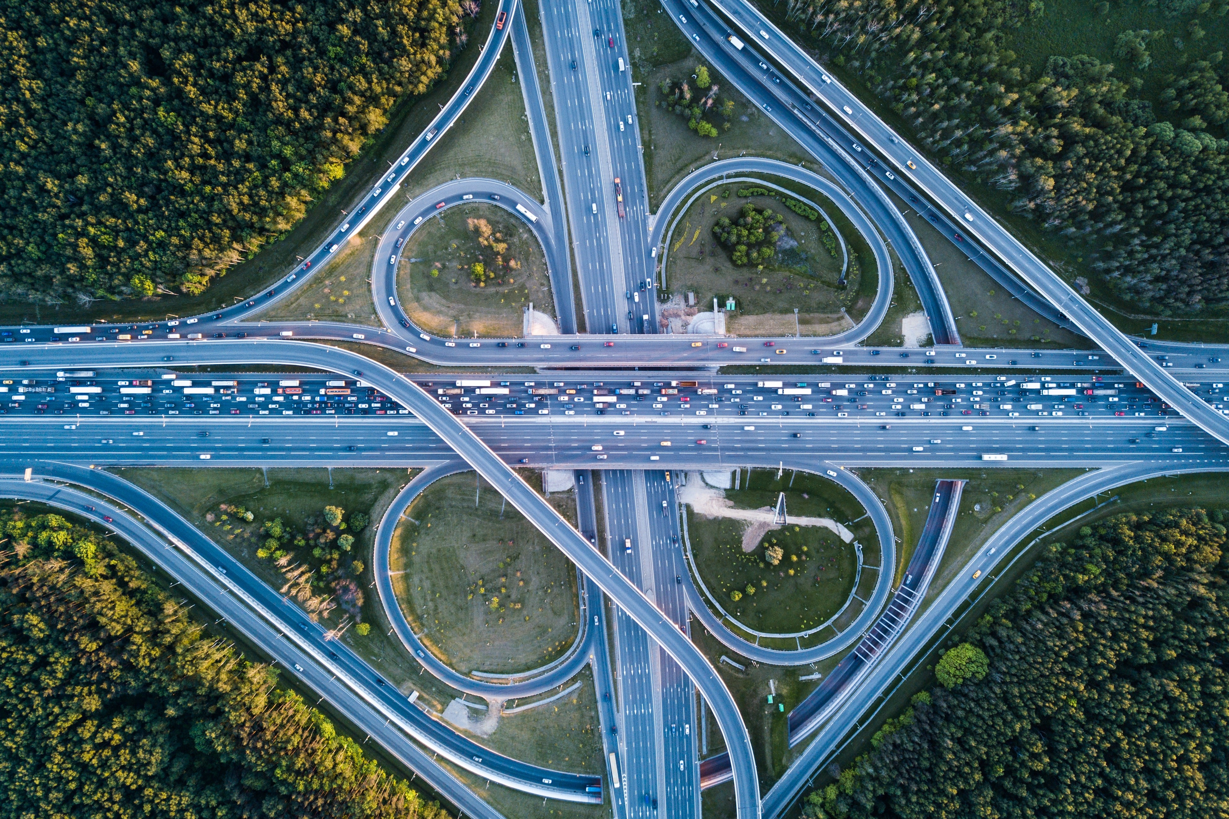 Aerial view of a complex highway interchange with heavy traffic HD Wallpaper