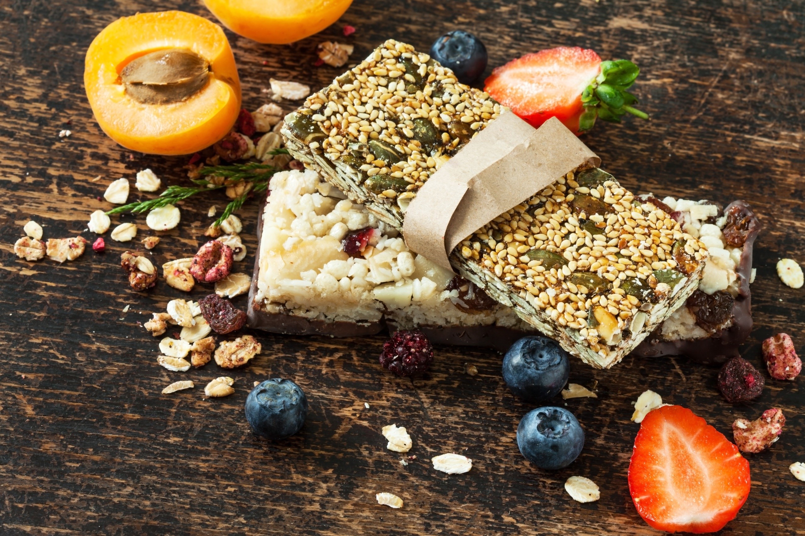 Granola bars with fruit and berries on a wooden table HD Wallpaper