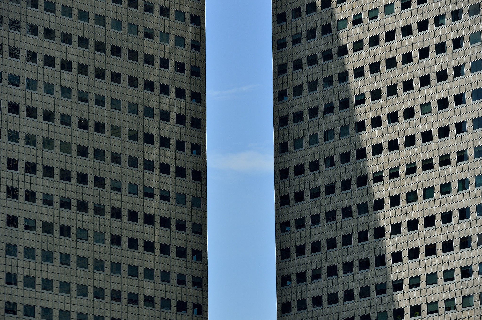 Two skyscrapers with many windows against a clear blue sky HD Wallpaper