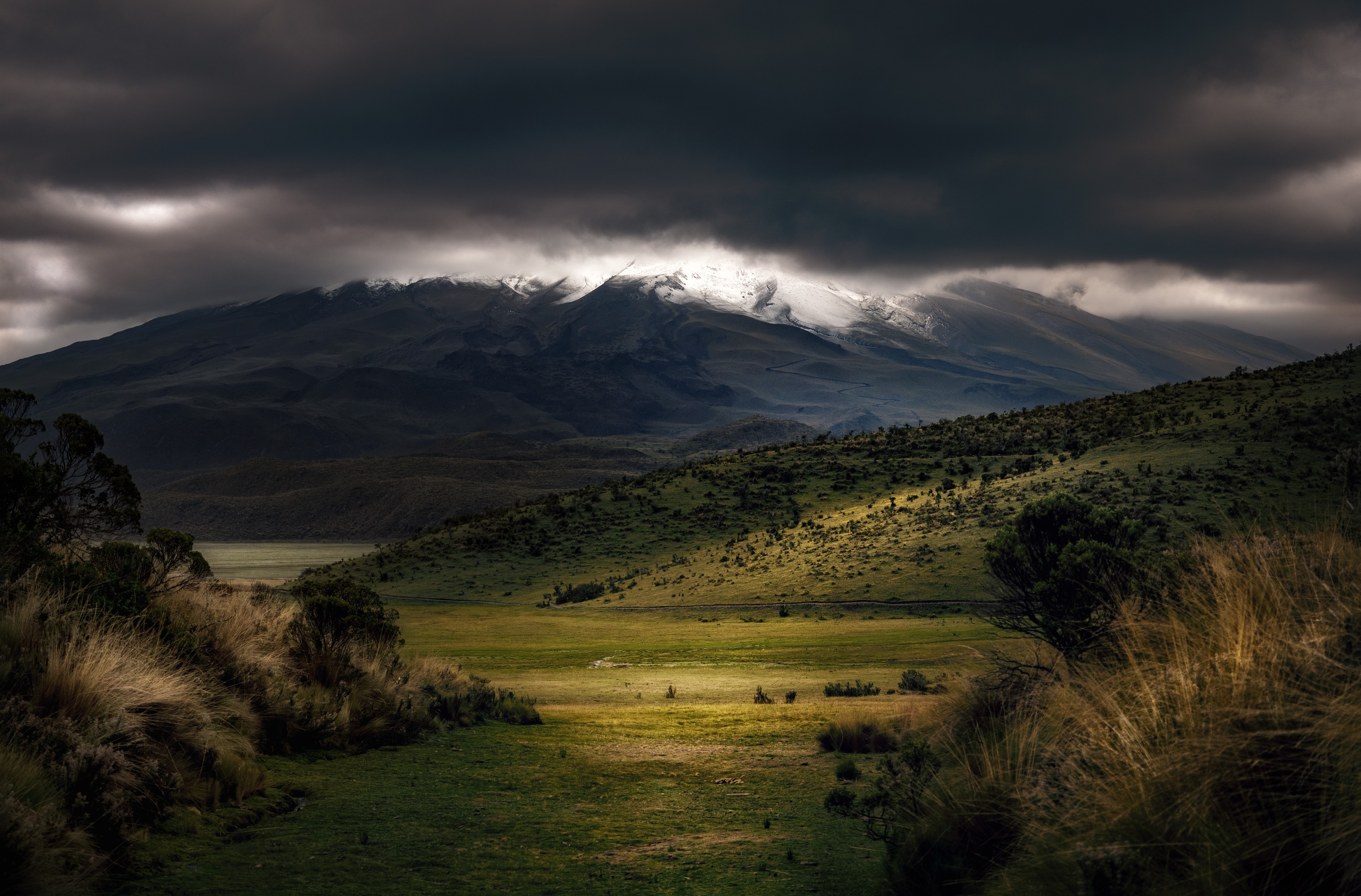 Overcast landscape with snow-capped mountains HD Wallpaper