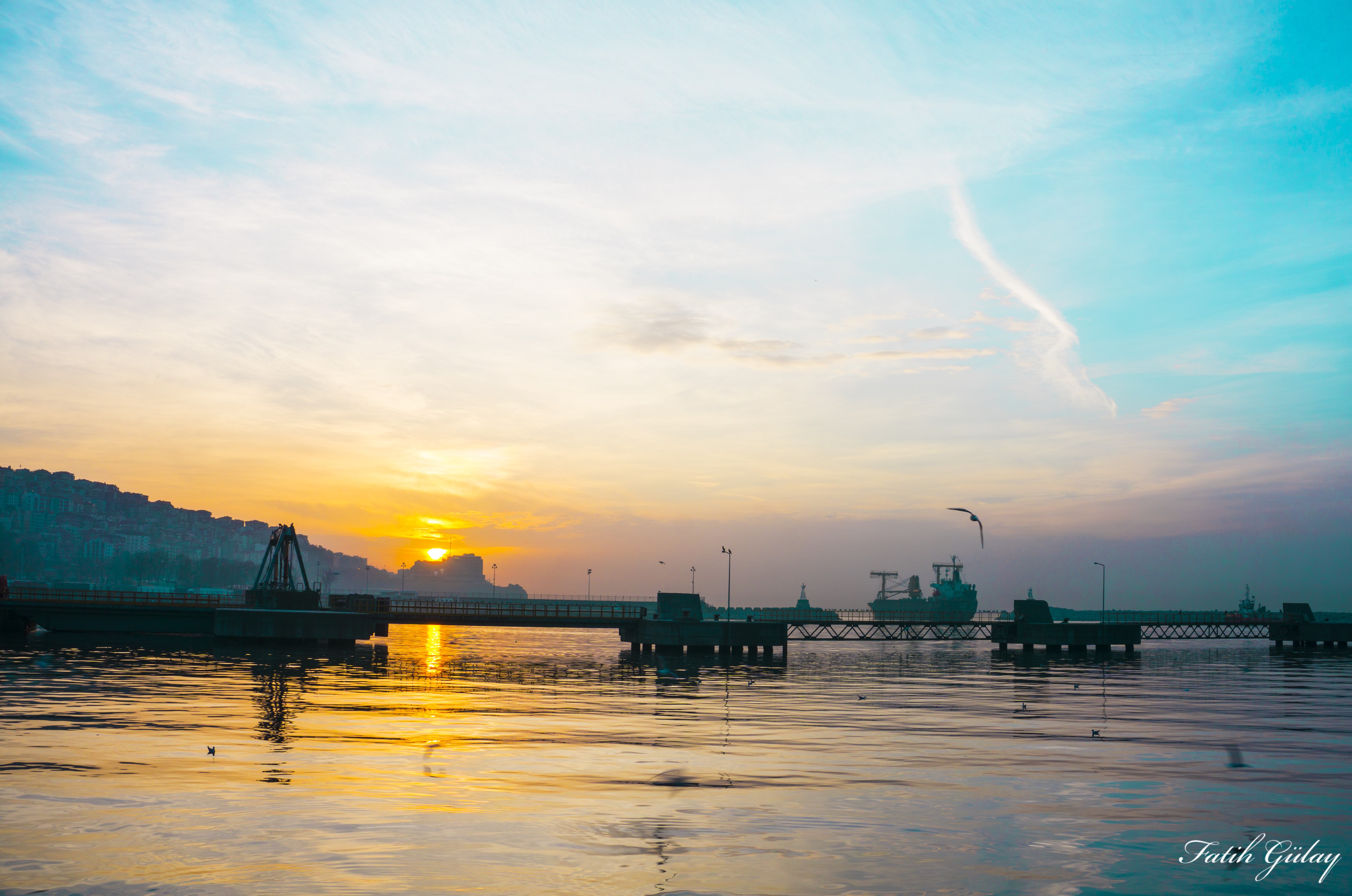 4K sunset over sea with city and port HD Wallpaper