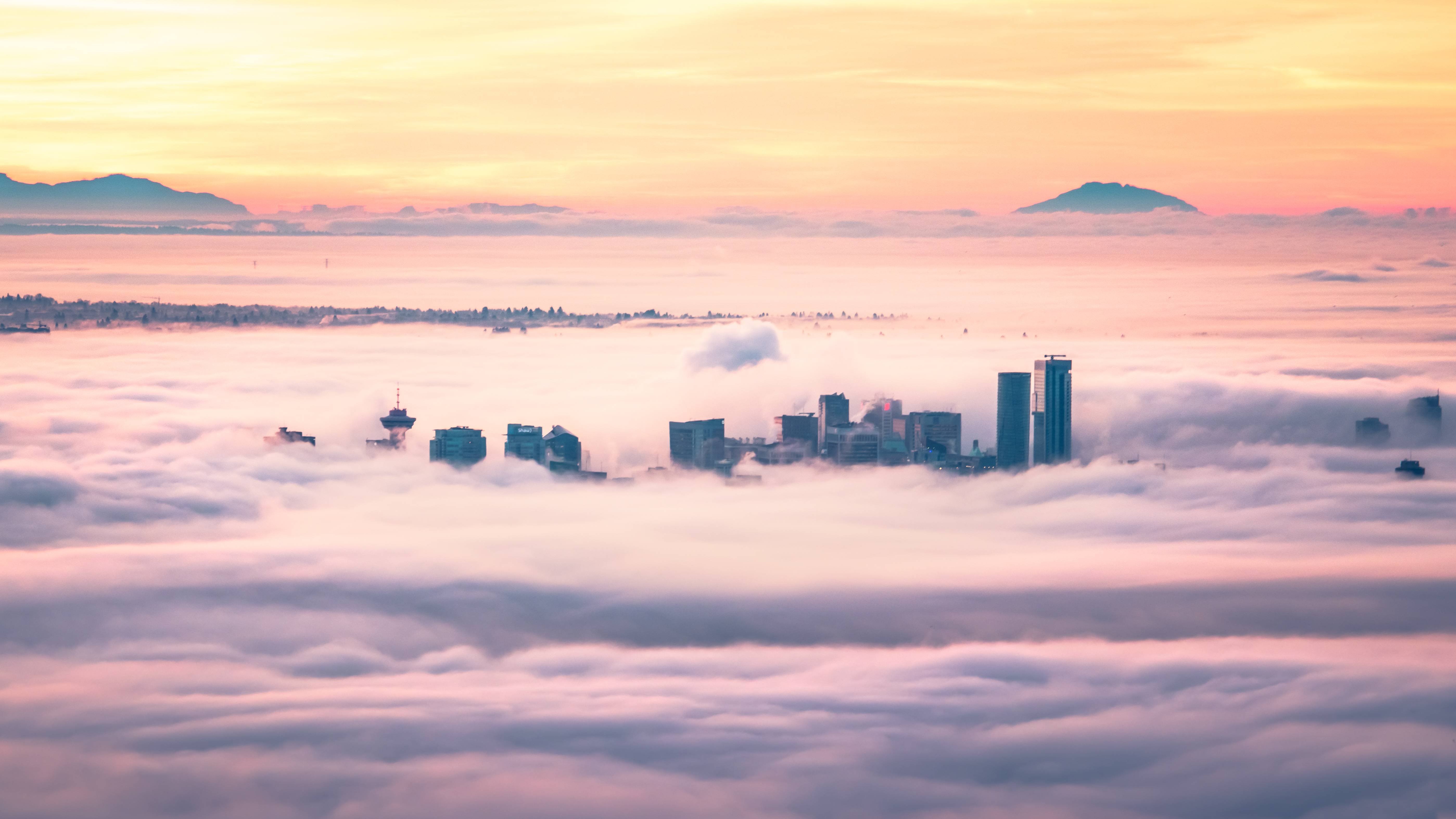 4K Vancouver city skyline above clouds at sunrise HD Wallpaper