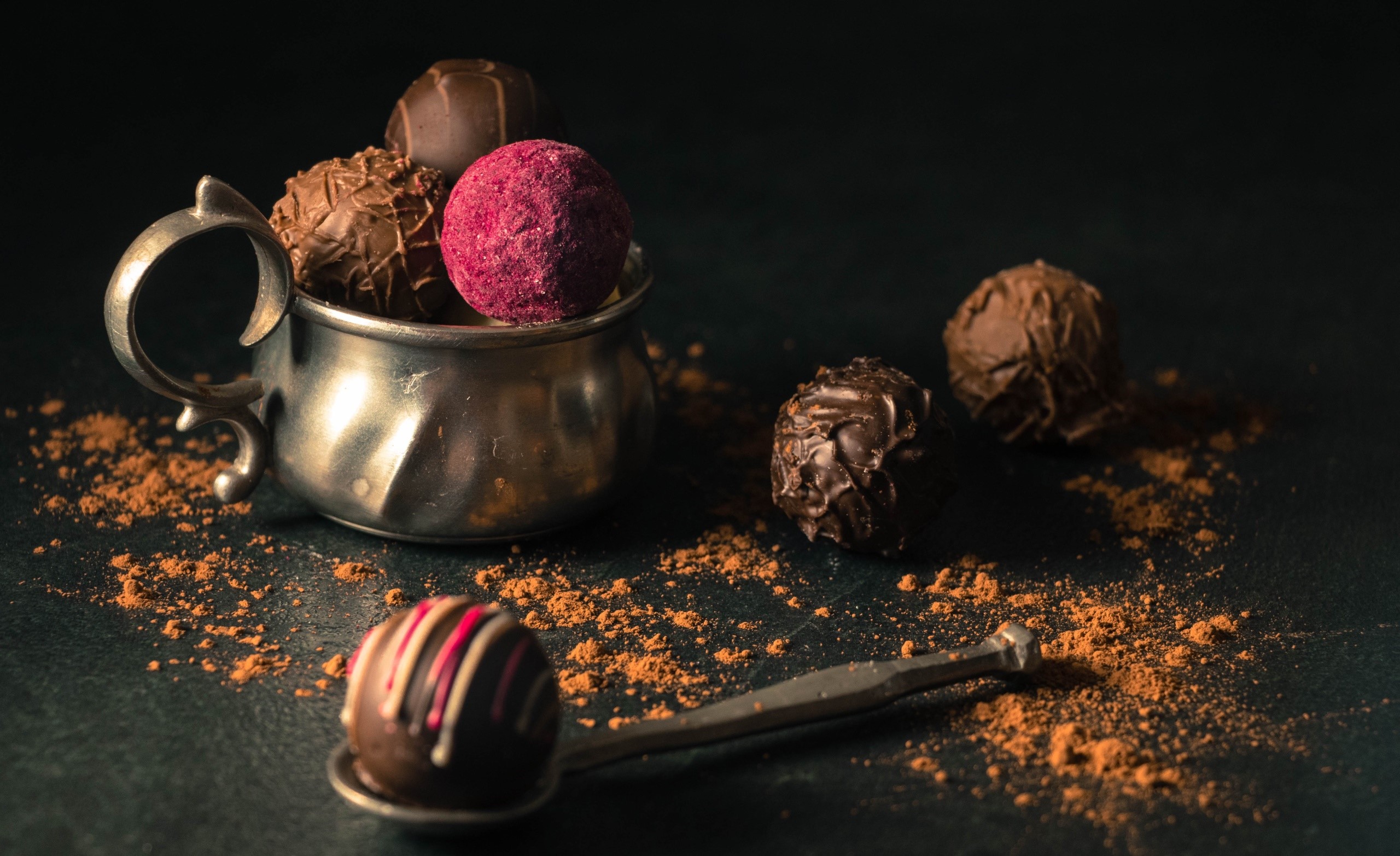 Chocolates and truffles in a metal cup with cocoa powder HD Wallpaper