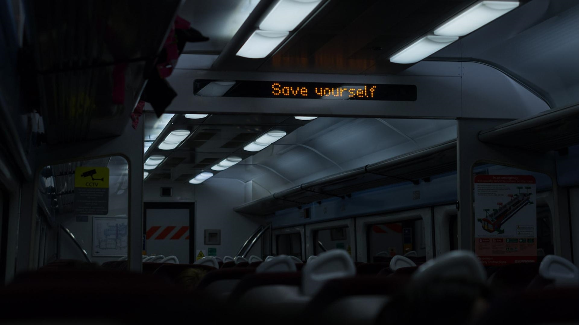 Train interior with "Save yourself" message HD Wallpaper