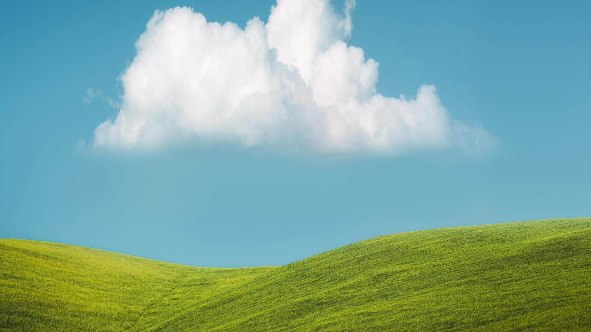 Green rolling hills under a blue sky with clouds HD Wallpaper