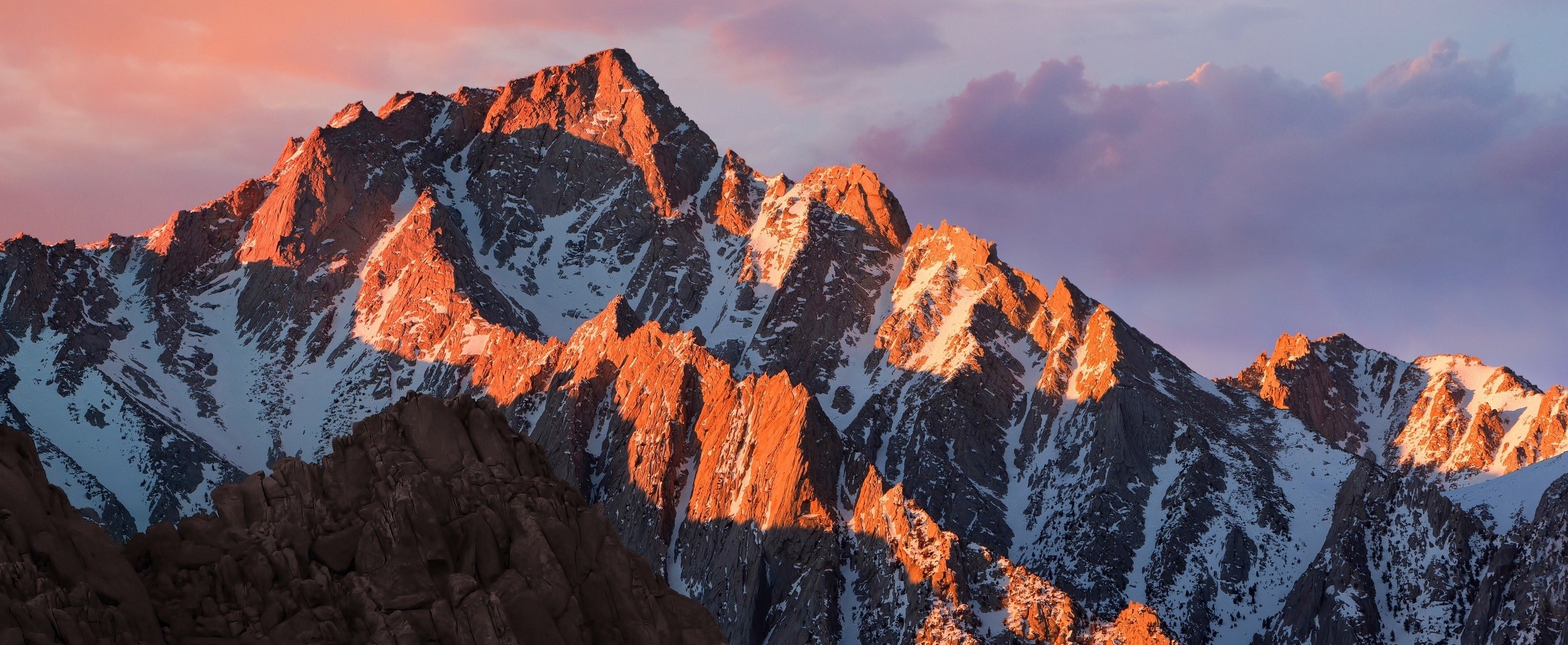 Mountain range at sunrise with snow and rocks HD Wallpaper