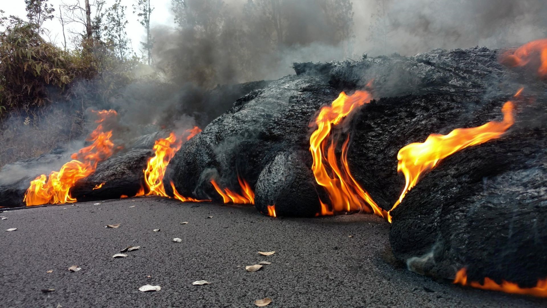 Lava flow with fire and smoke on a road HD Wallpaper