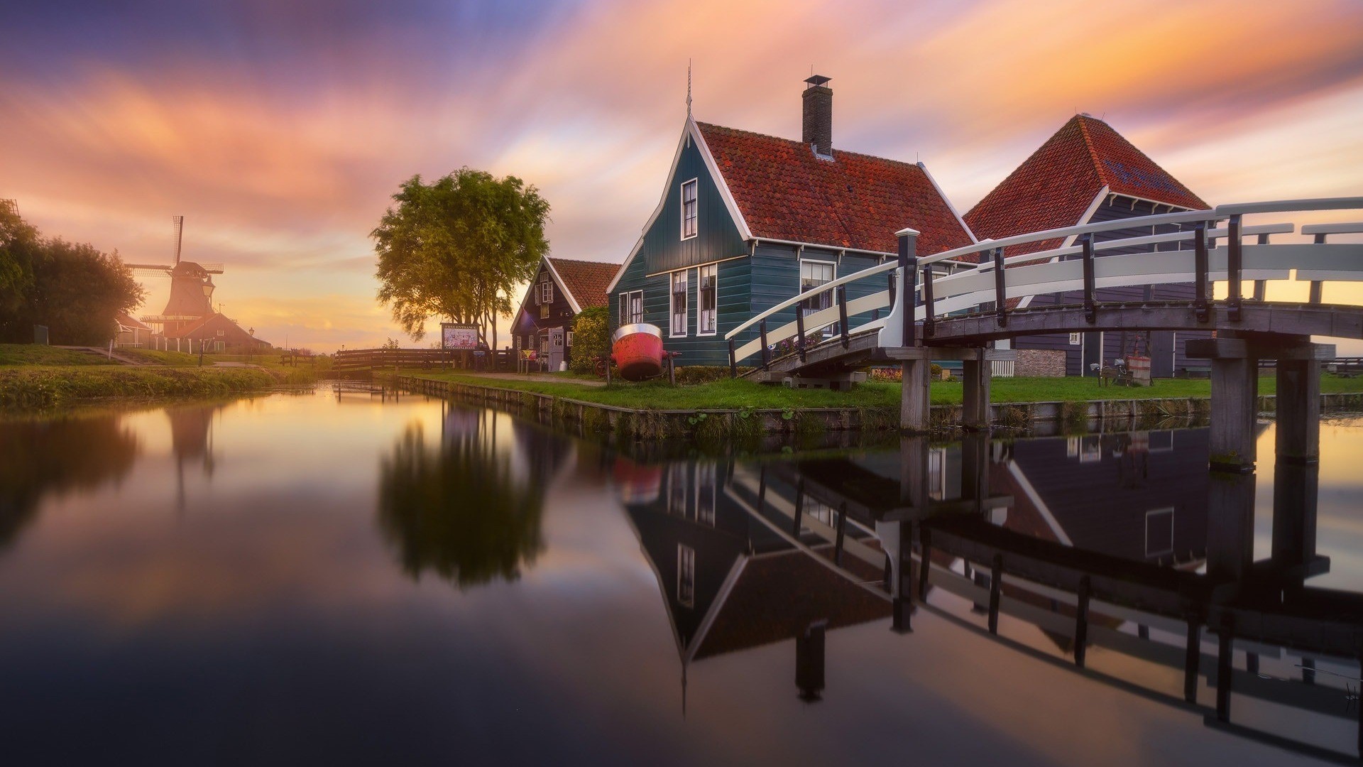 Village with windmill and bridge at sunset with reflection HD Wallpaper