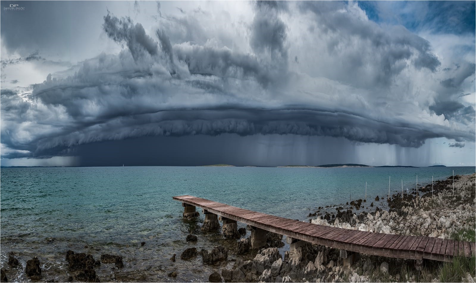 Stormy clouds over the Adriatic Sea with a wooden pier HD Wallpaper