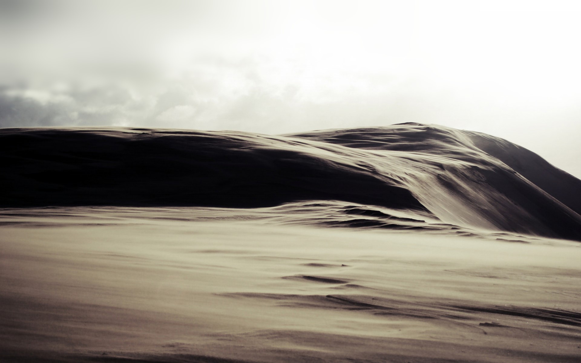 Sand dunes under a cloudy sky HD Wallpaper