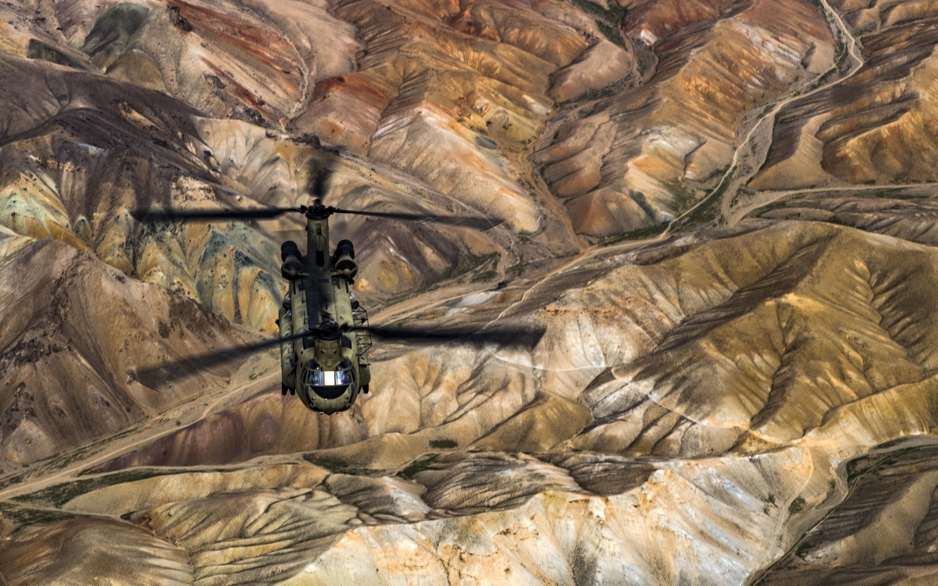 Boeing CH-47 Chinook helicopter flying over mountainous terrain HD Wallpaper