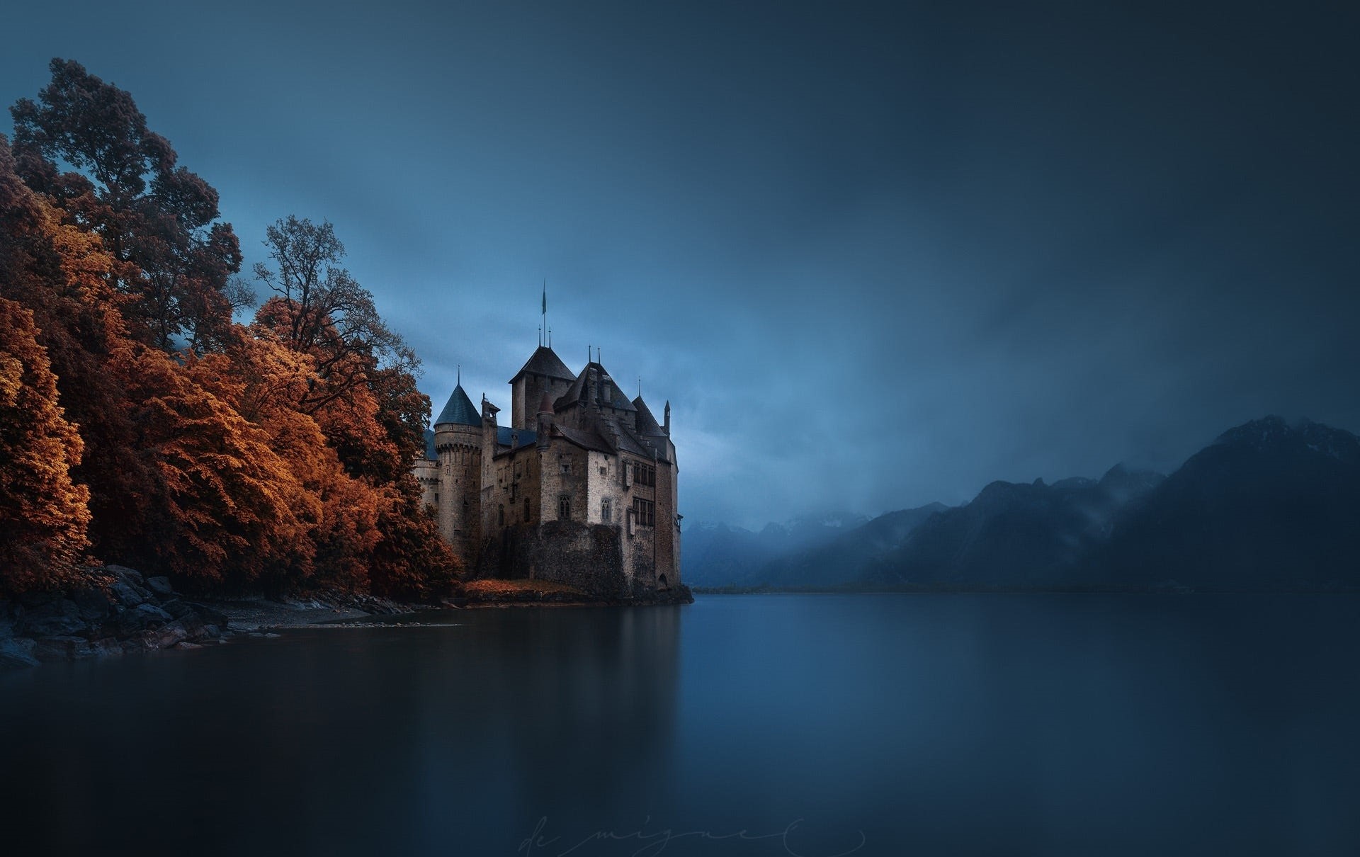 Castle on a lake with autumn trees and mountains HD Wallpaper