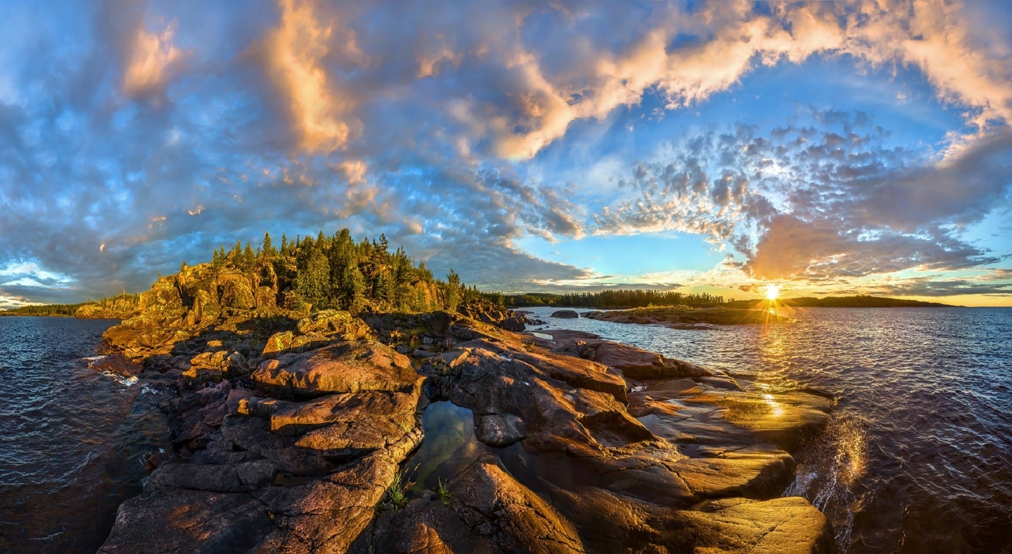 Sunset over rocky coastline with trees and clouds HD Wallpaper