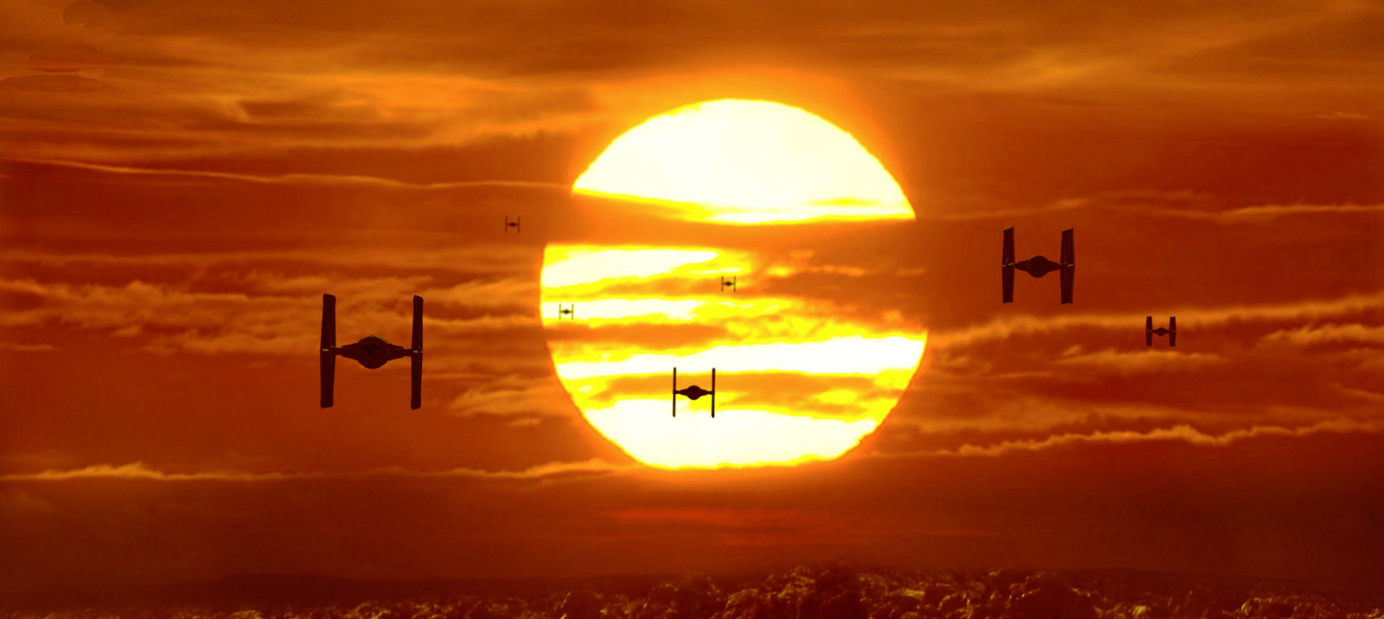 Star Wars TIE Fighters flying past a large sun HD Wallpaper