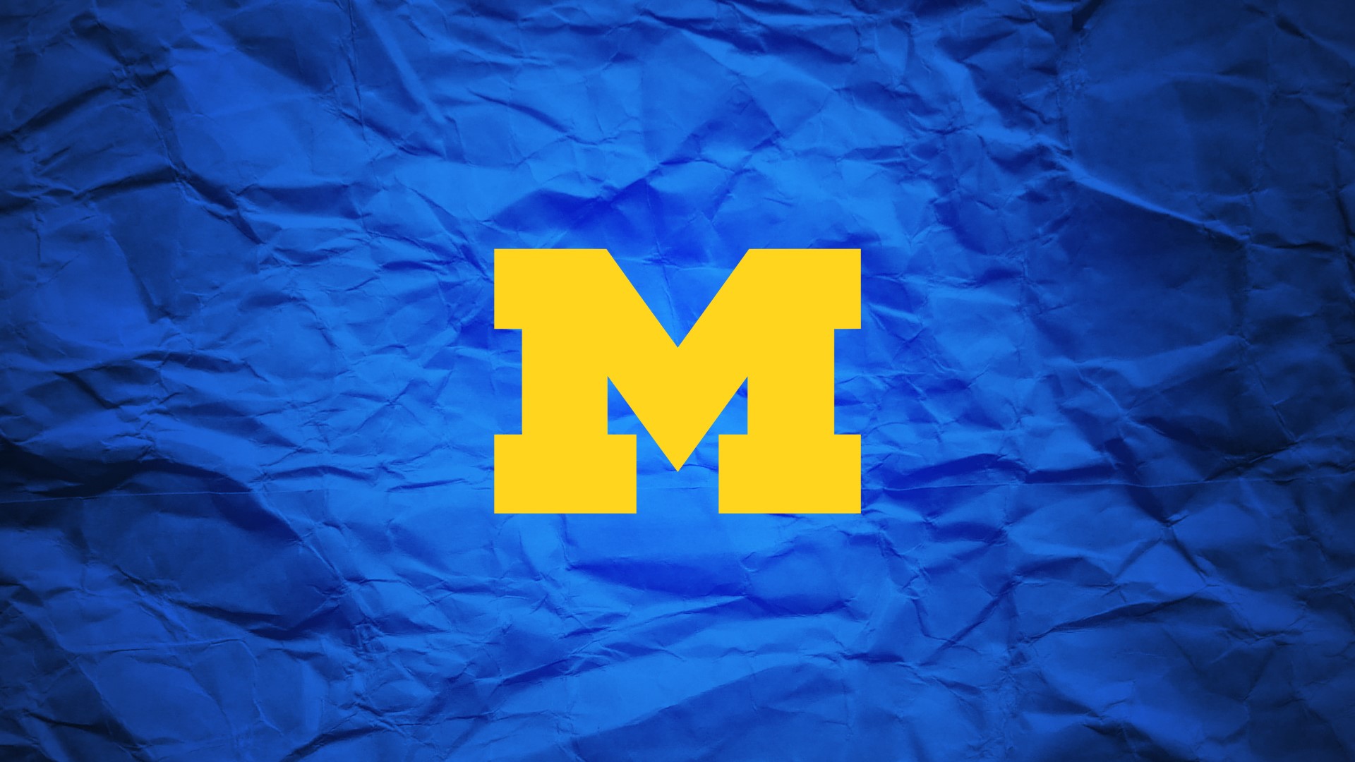 Yellow M logo on blue crumpled paper HD Wallpaper