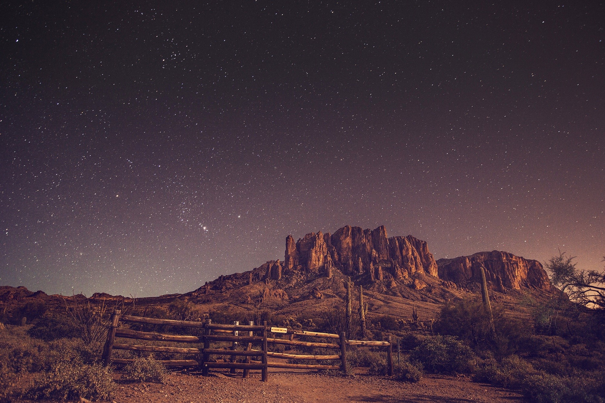 Desert landscape at night with stars and mountains HD Wallpaper