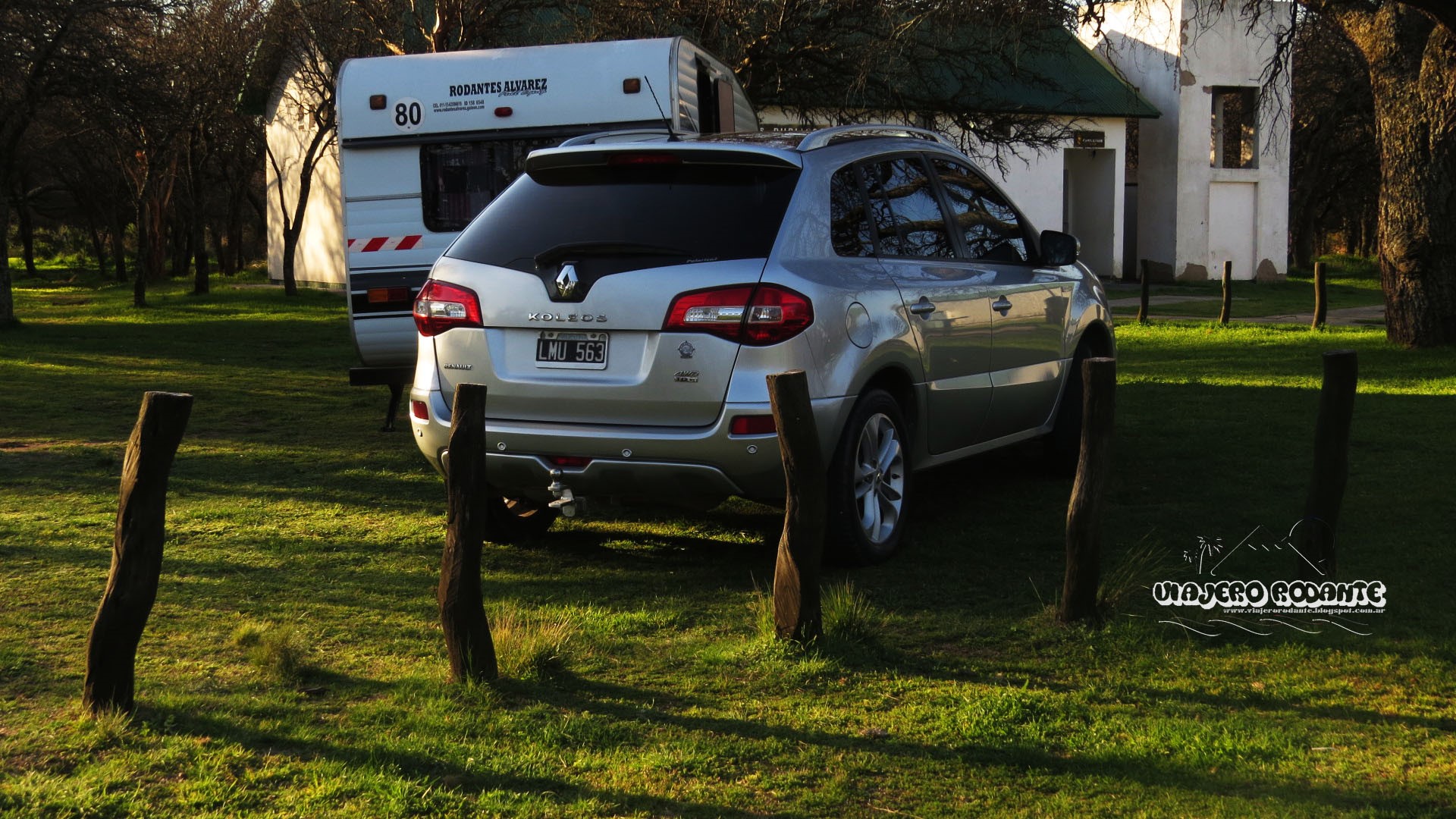 Renault Koleos and caravan in a grassy area with trees HD Wallpaper
