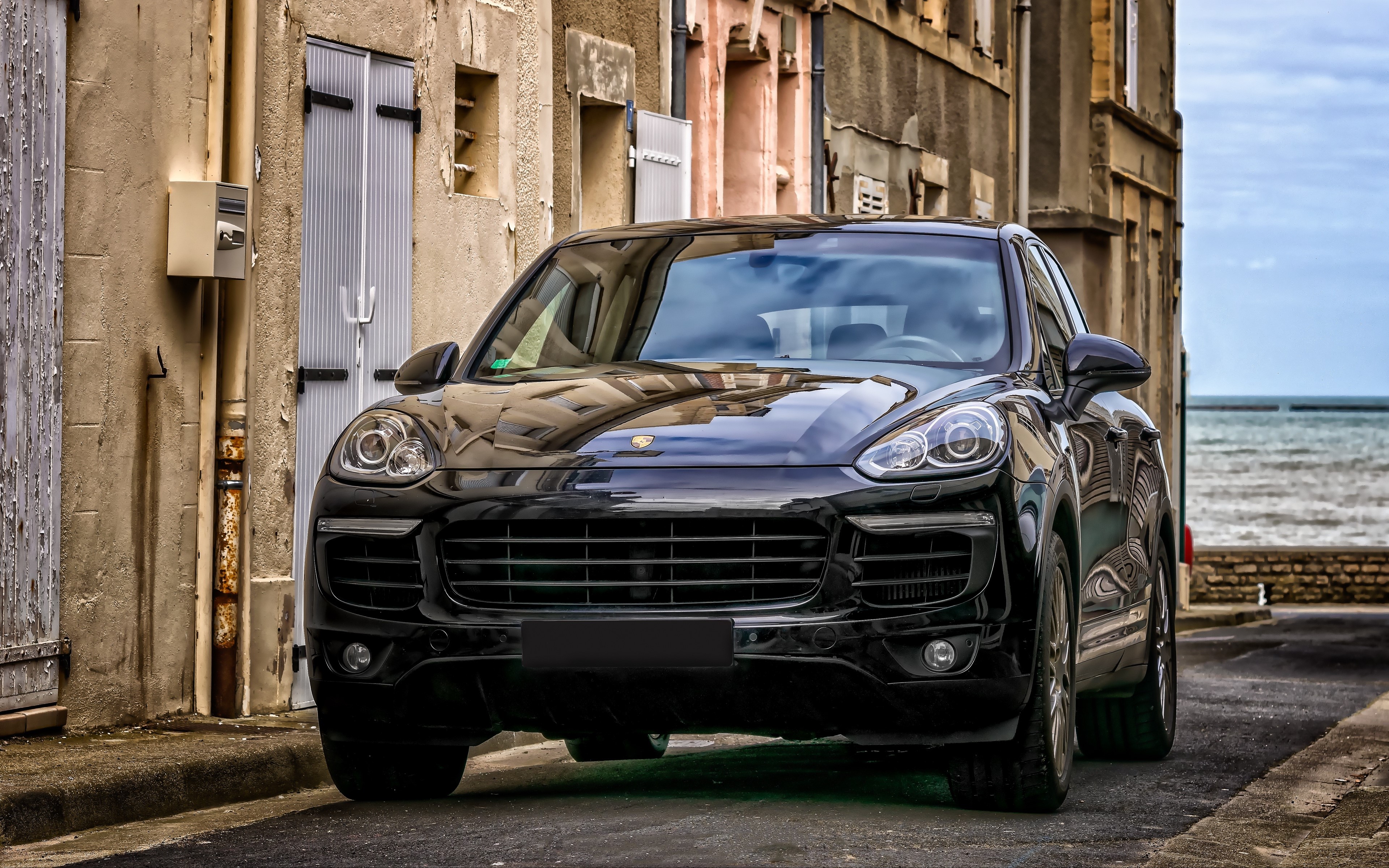 4K Porsche Cayenne parked by the sea HD Wallpaper