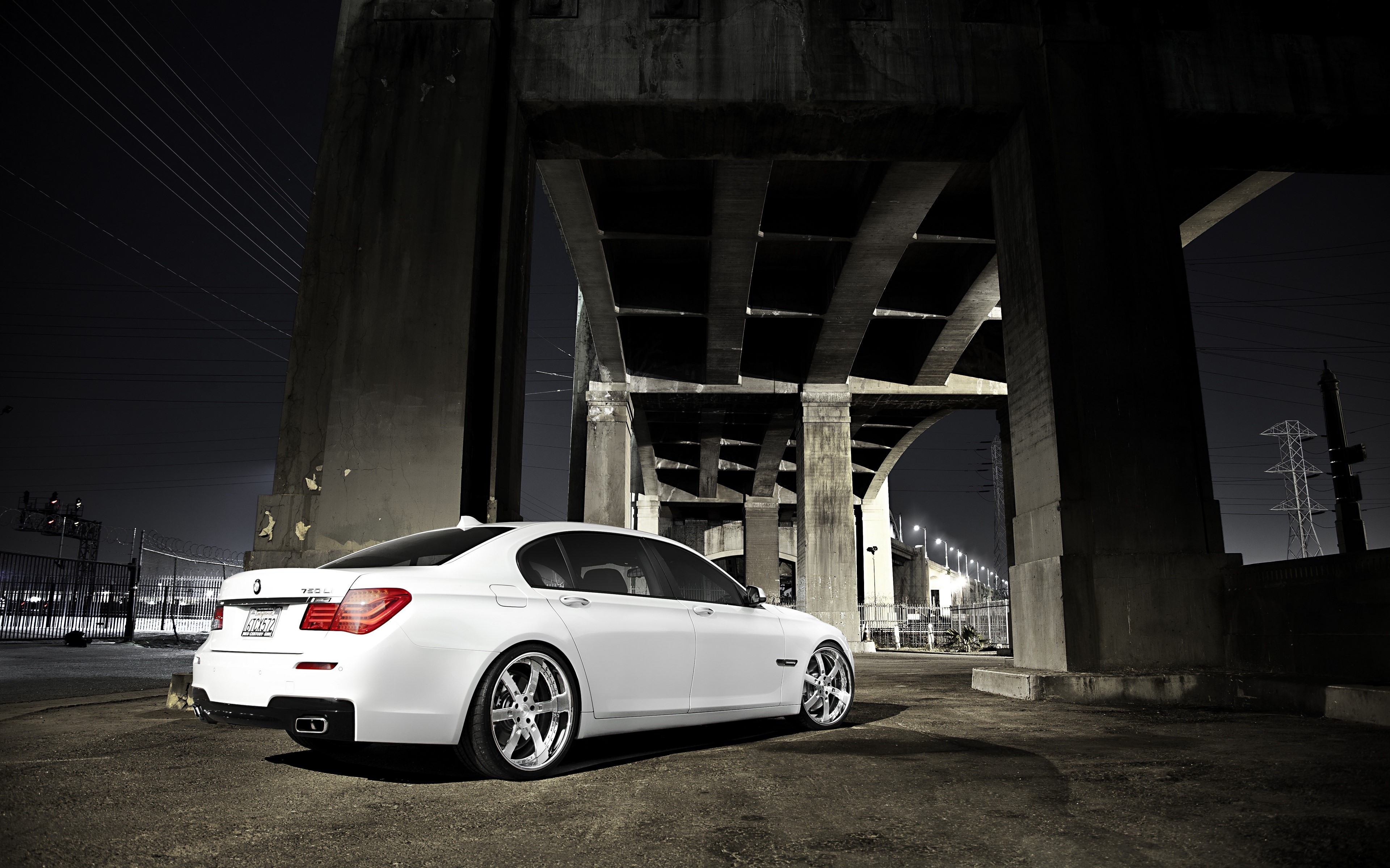 White BMW 7 Series car under a bridge at night HD Wallpaper
