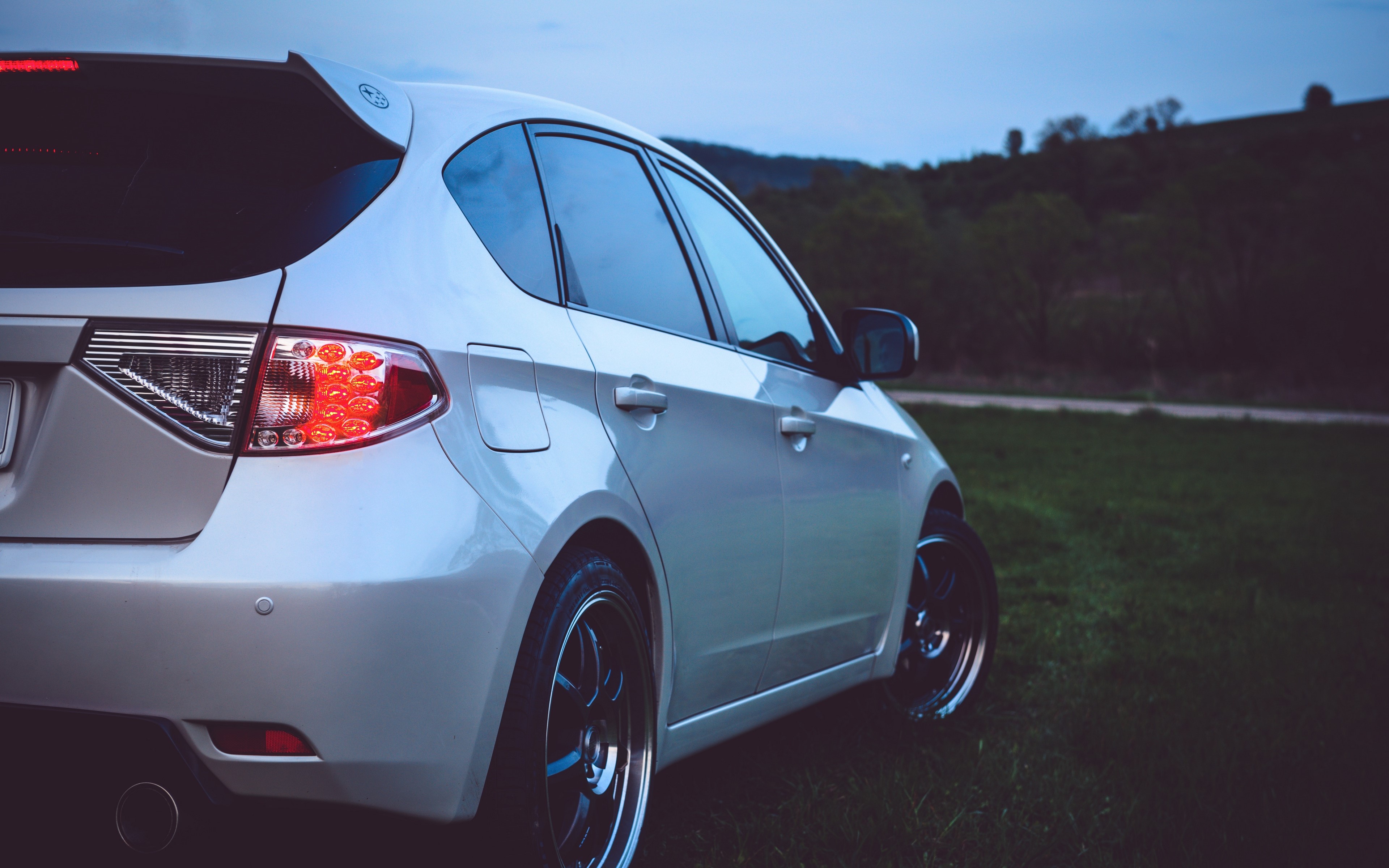 White Subaru Impreza parked outdoors HD Wallpaper
