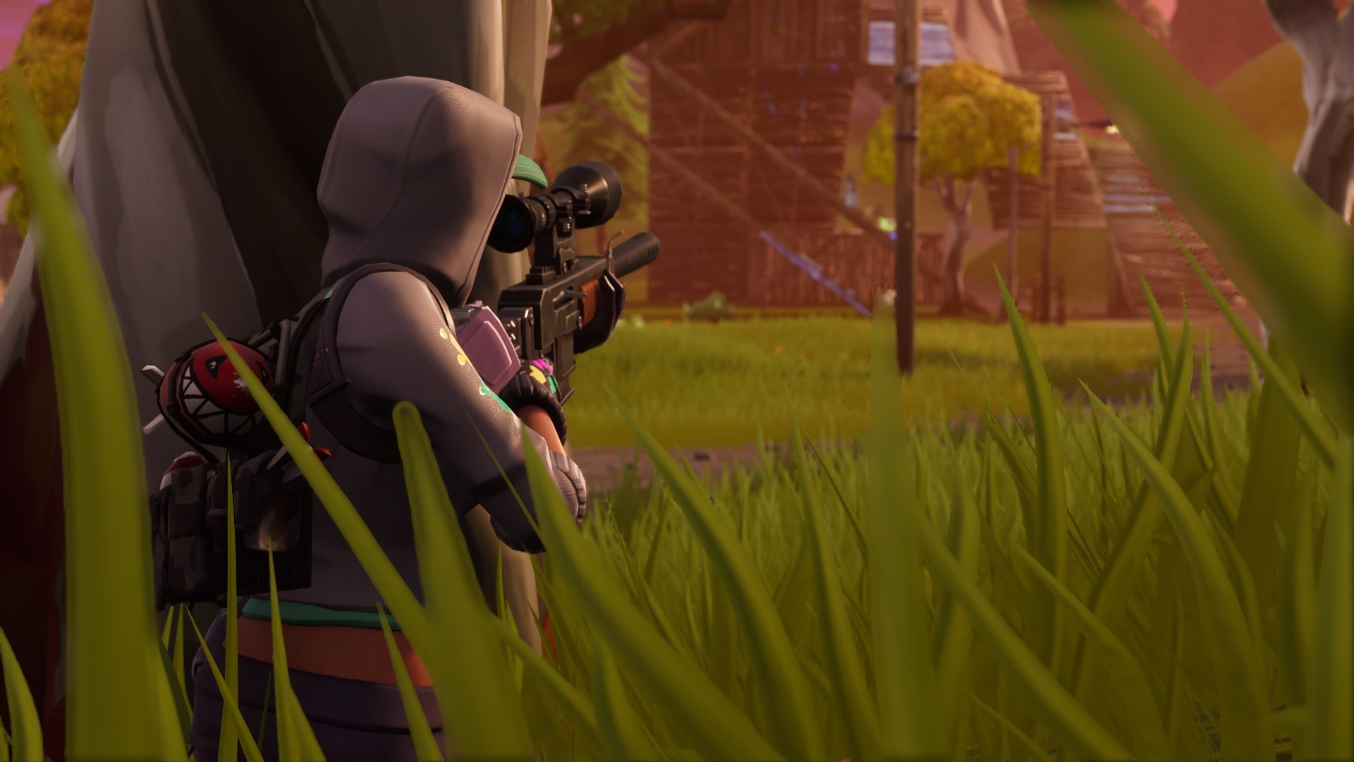Fortnite character aiming a sniper rifle in a grassy field HD Wallpaper