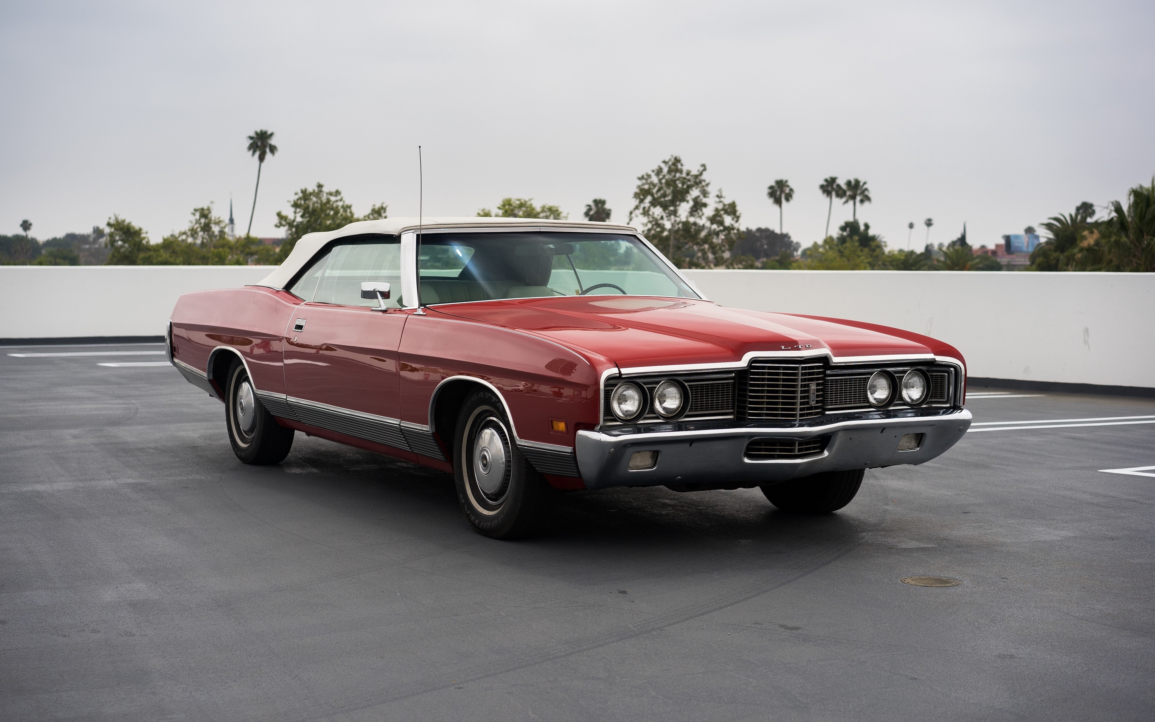 Red convertible car on a rooftop parking lot HD Wallpaper