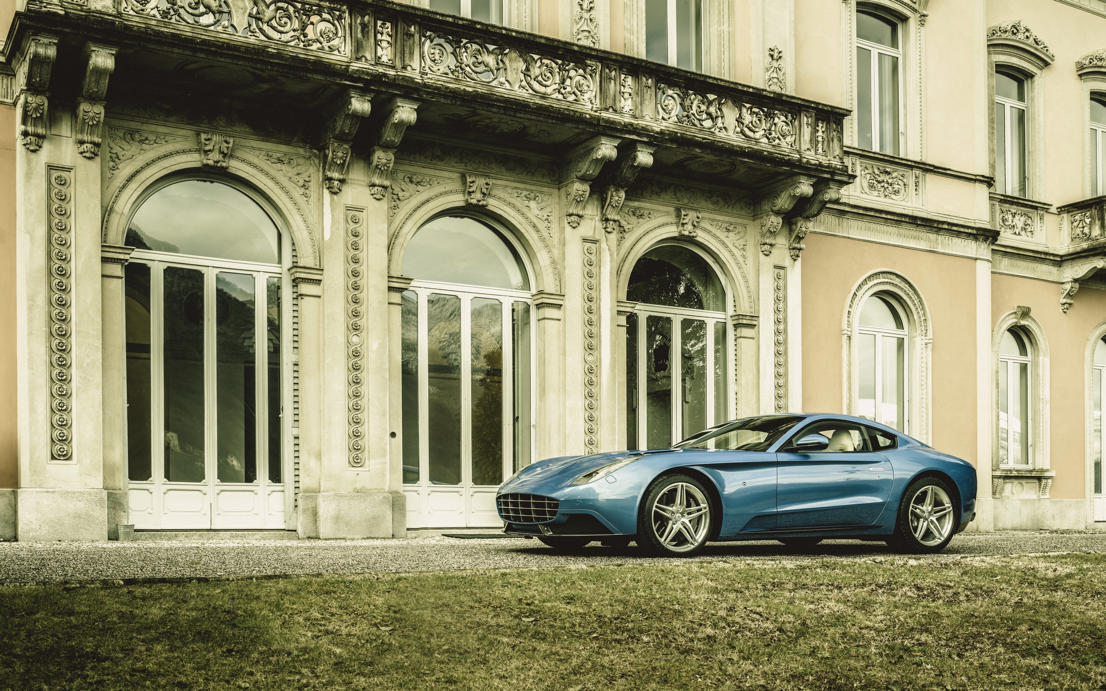 Blue Ferrari parked in front of a mansion HD Wallpaper