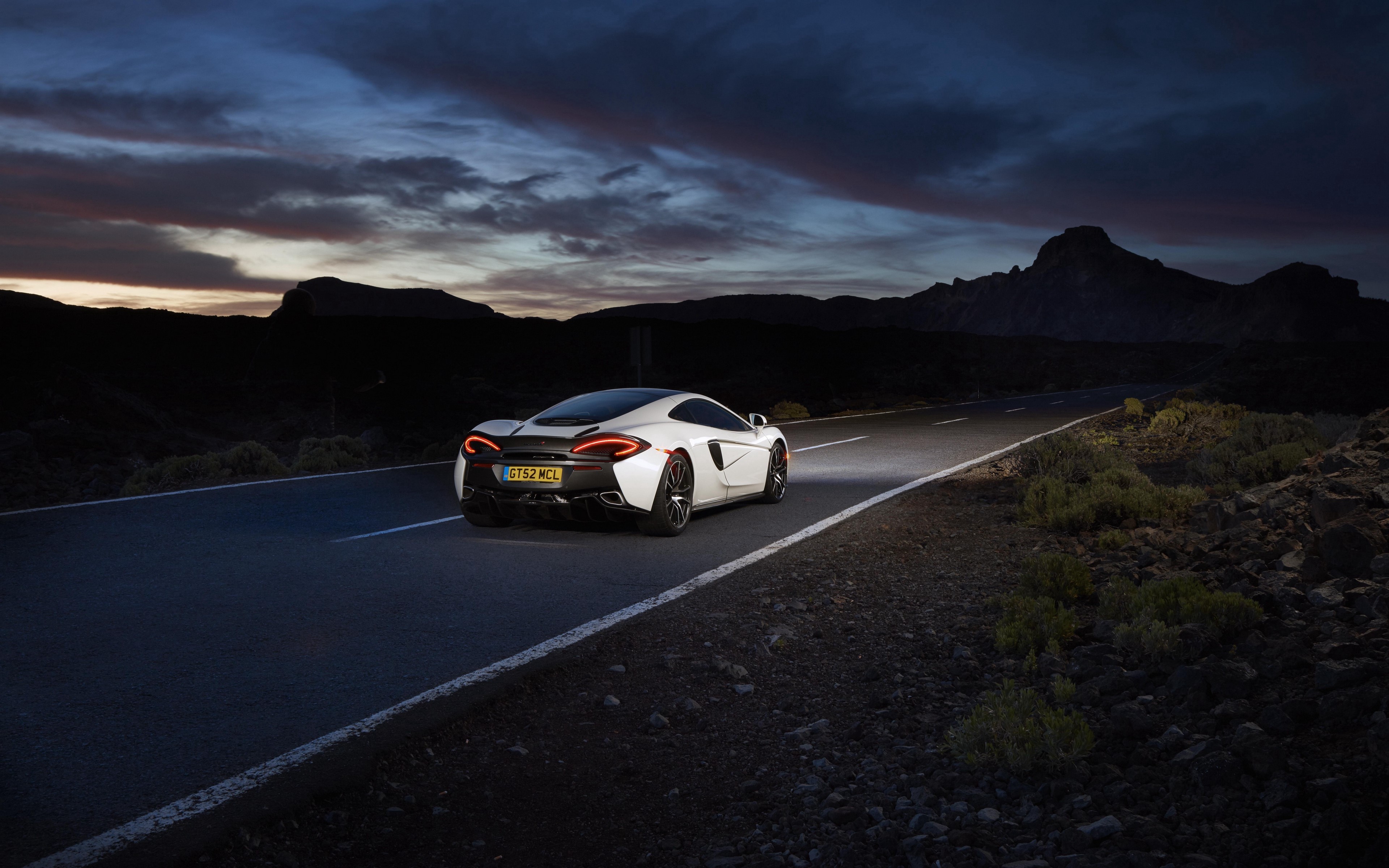 White McLaren 570S car on a road at dusk HD Wallpaper