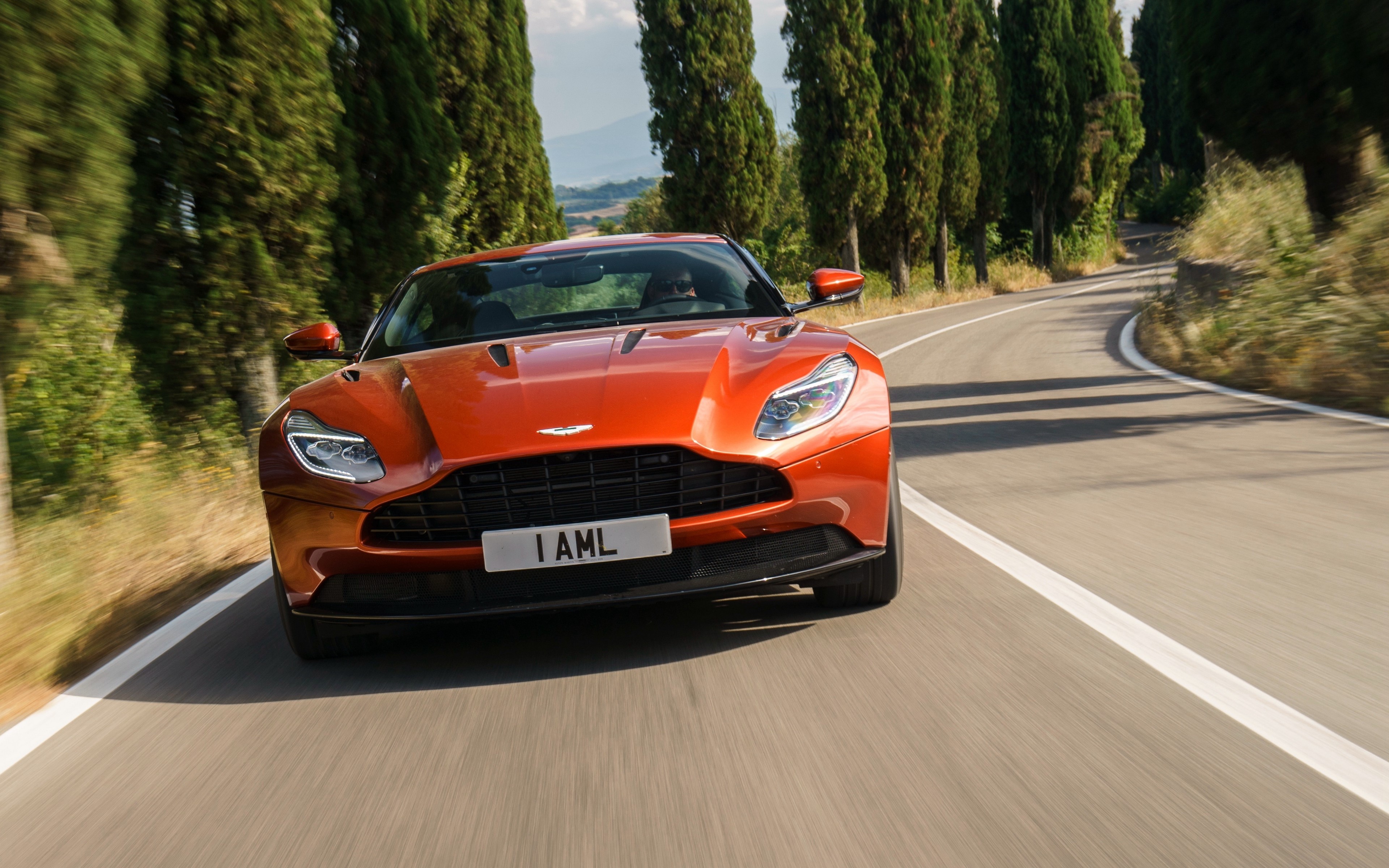 Aston Martin DB11 on a winding road HD Wallpaper