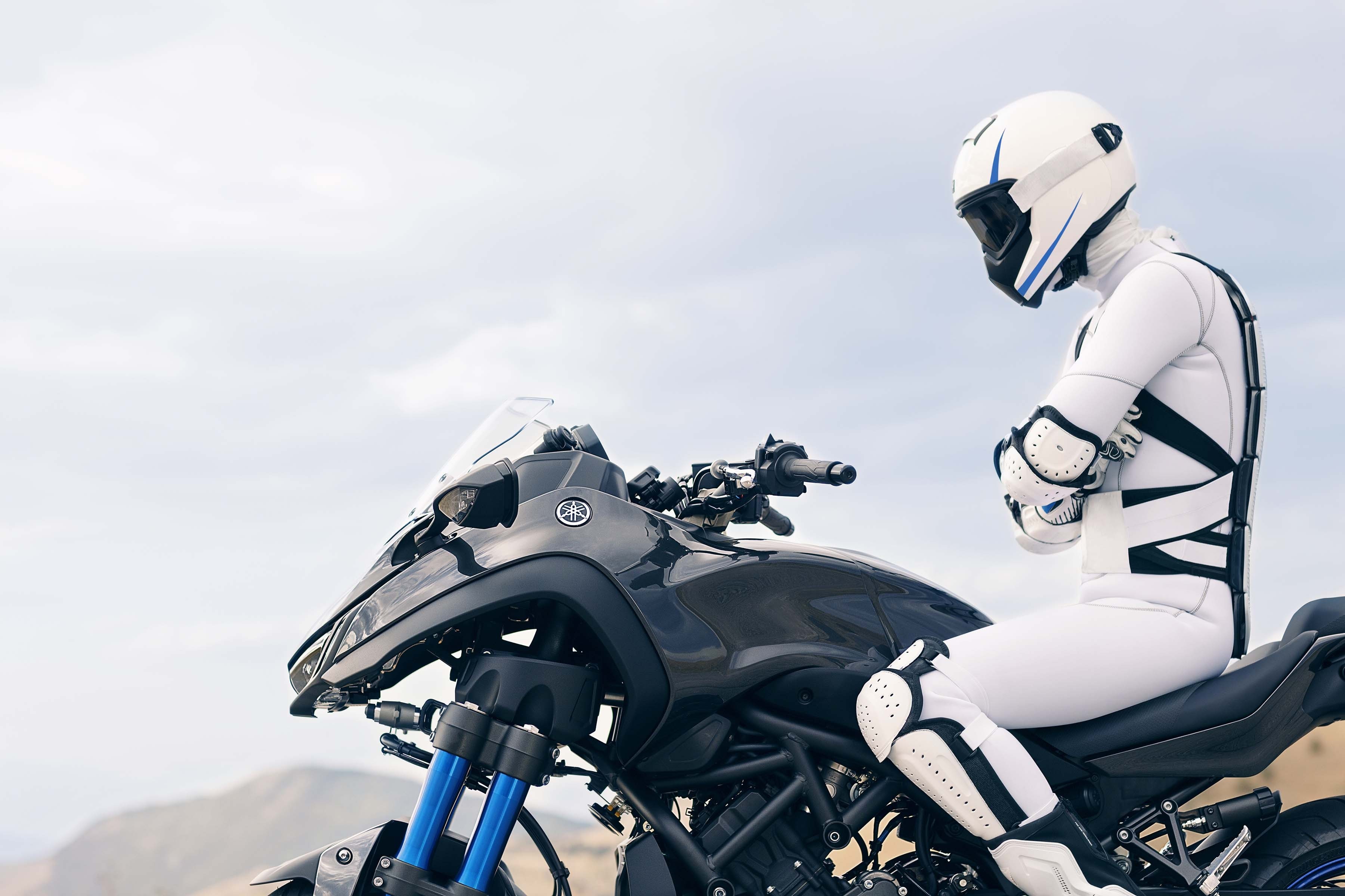 Yamaha Niken motorcycle with rider in white suit HD Wallpaper