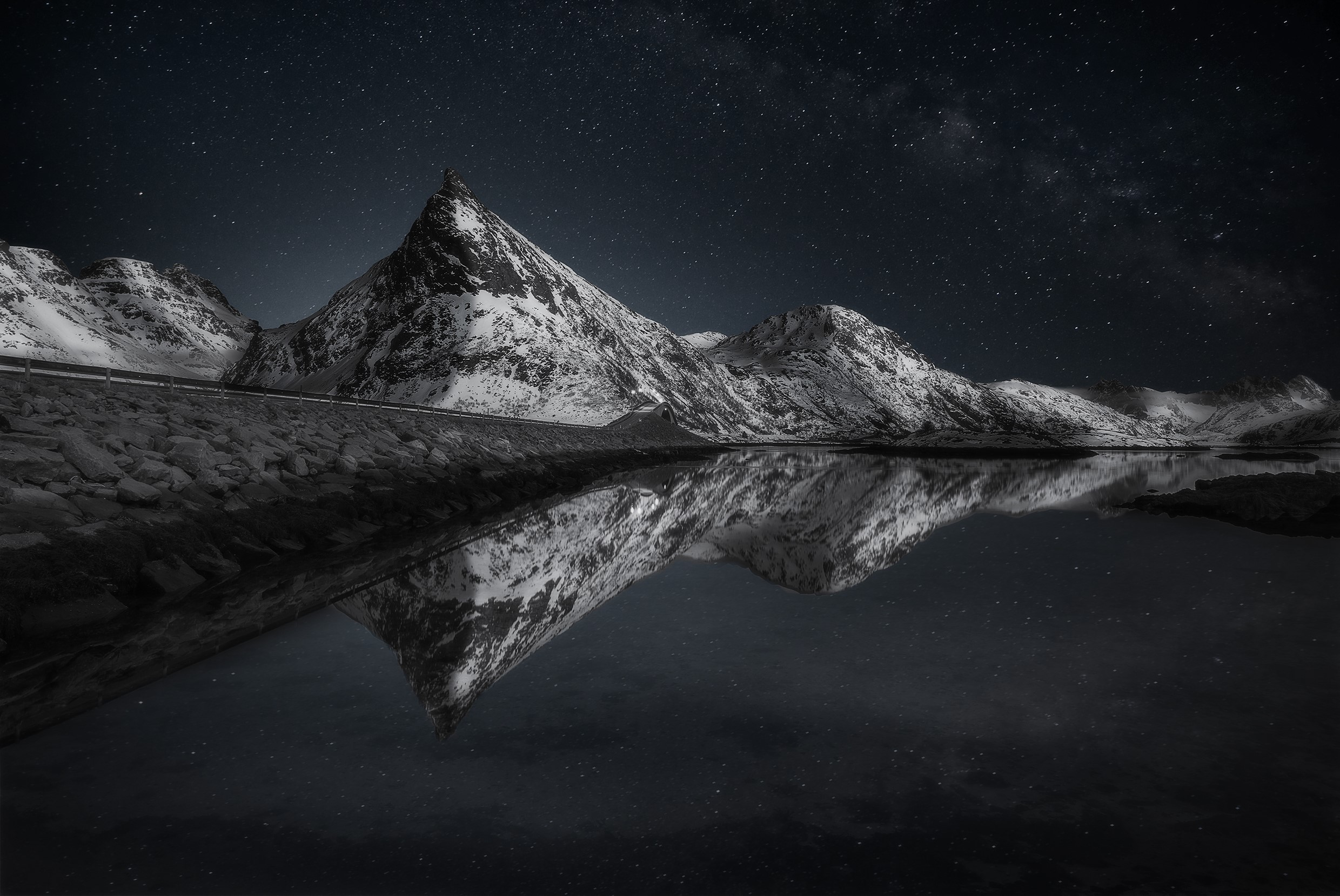 Snowy mountains reflected in water under starry night sky HD Wallpaper