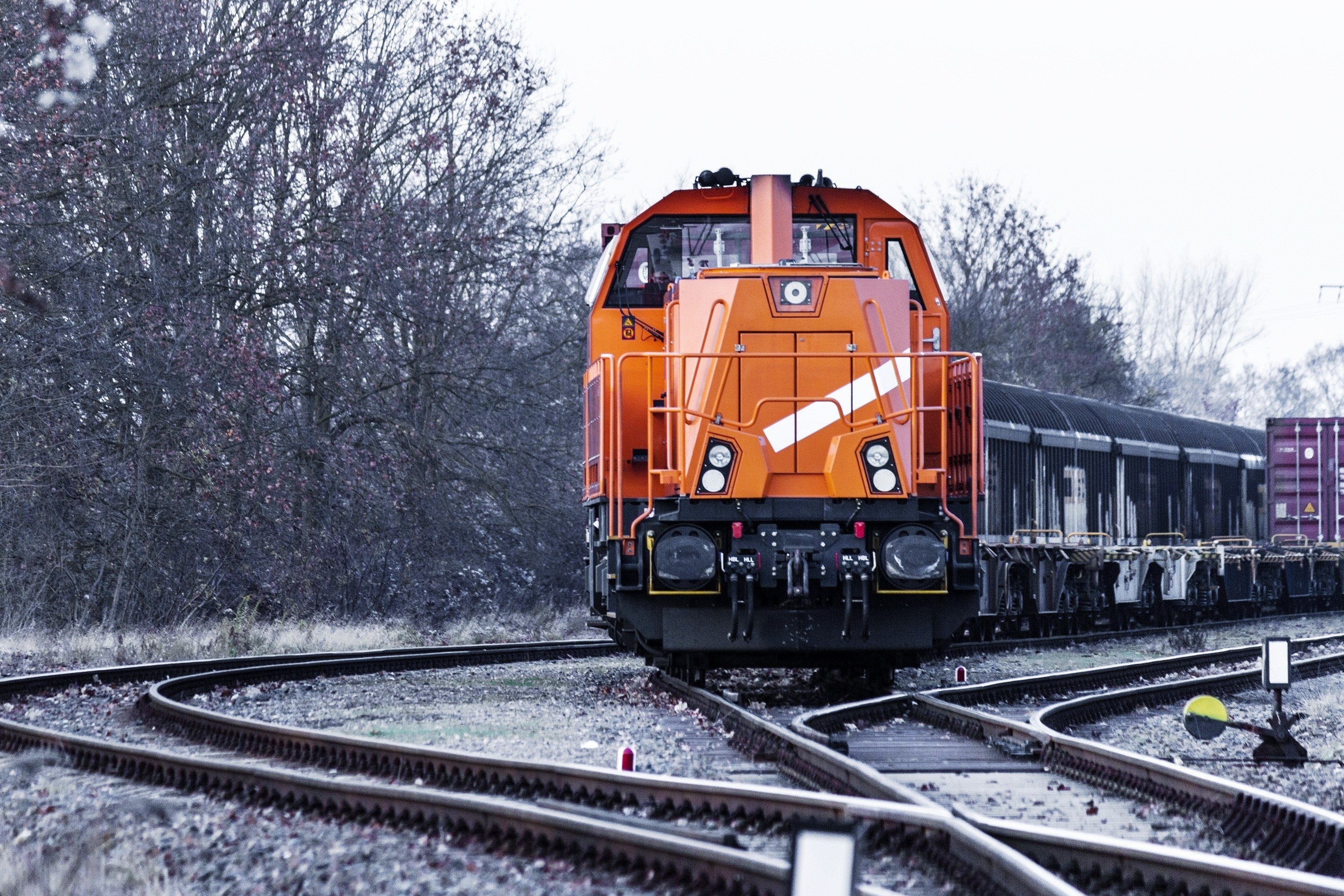 Orange train on railway tracks HD Wallpaper