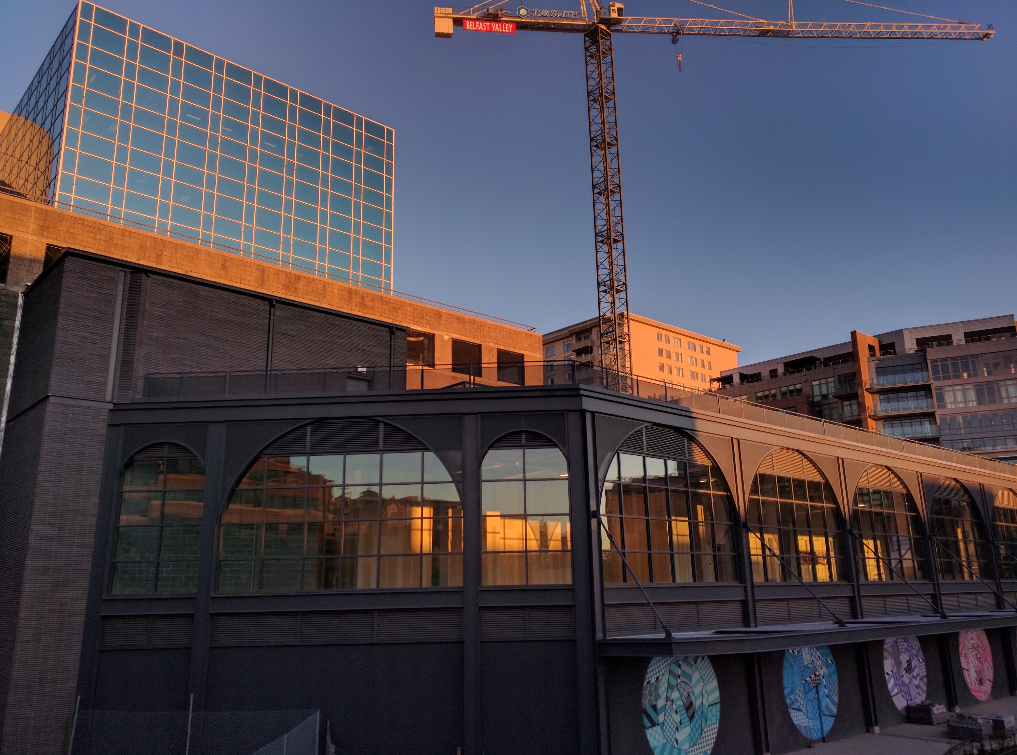 Construction site with crane and modern buildings HD Wallpaper